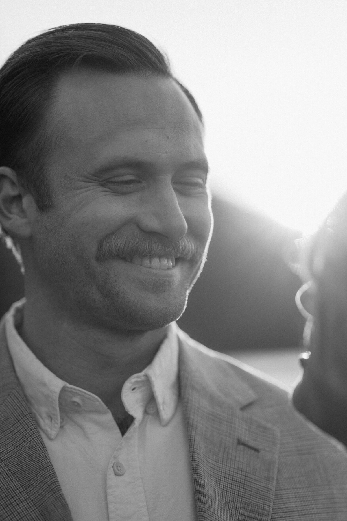 close up of groom's smiling and joyous face as he looks at the bride after their elopement in Bend, OR