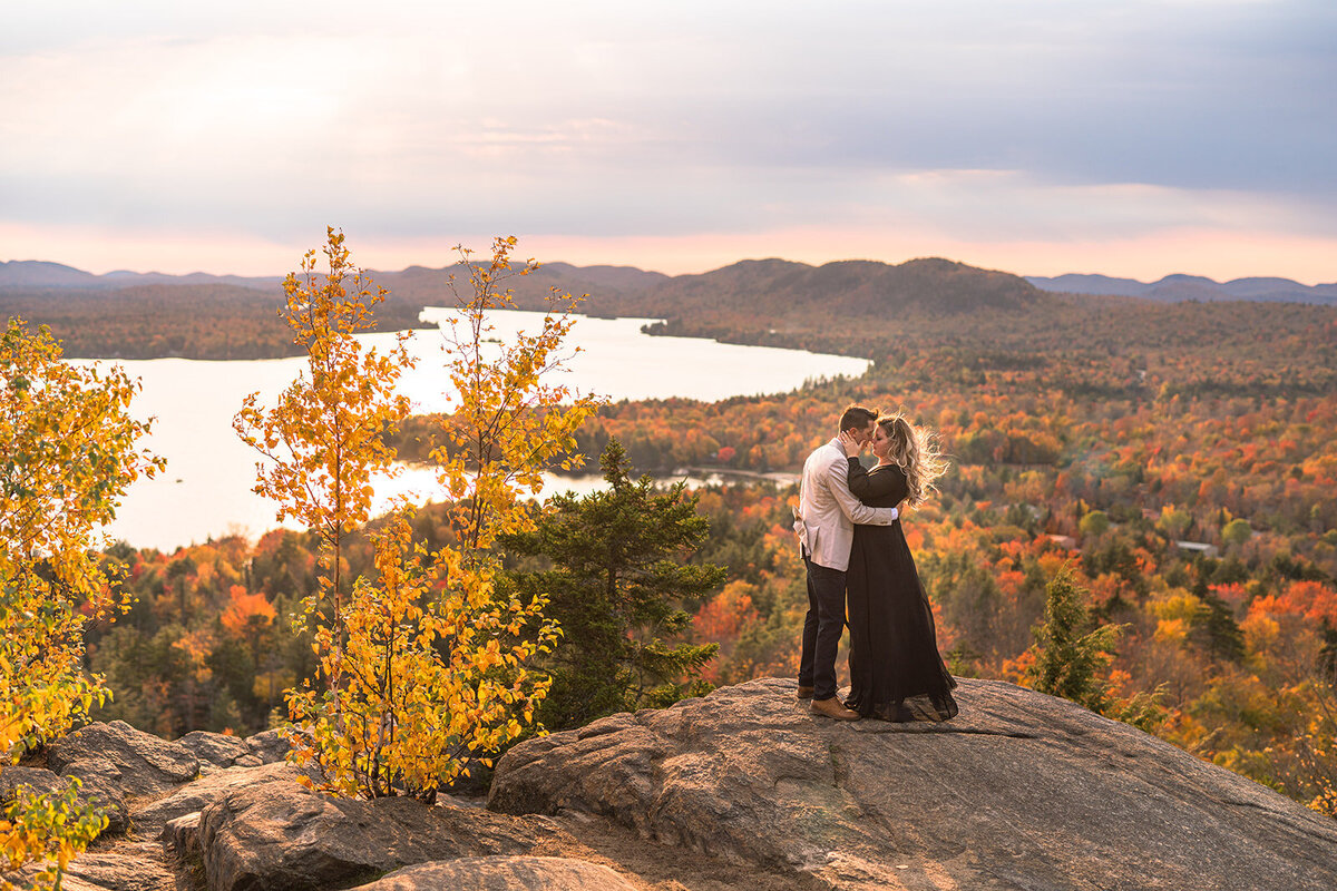 Couple embracing with a view over the fall landscape at Finger Lakes, NY