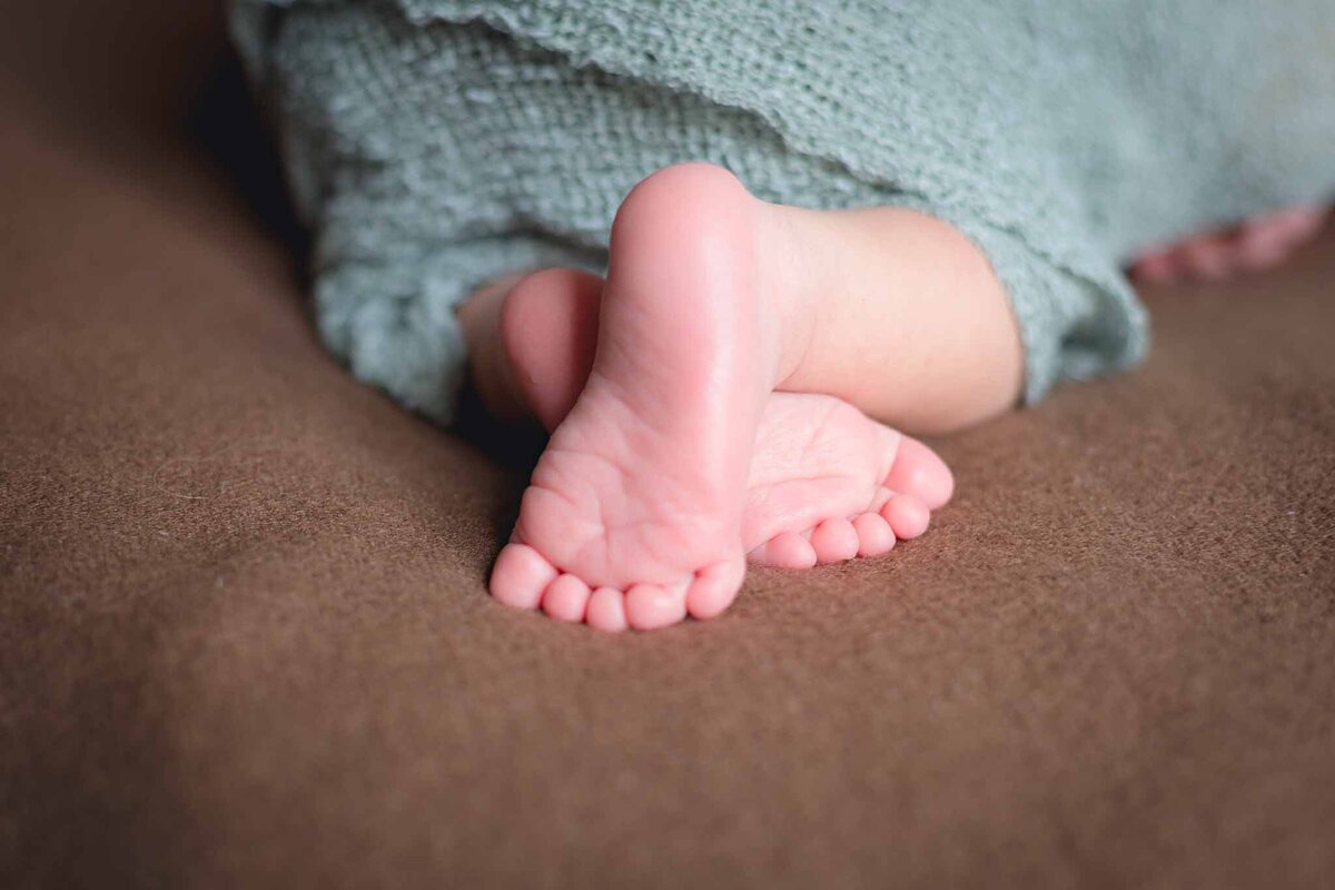 Newborn feet crossed