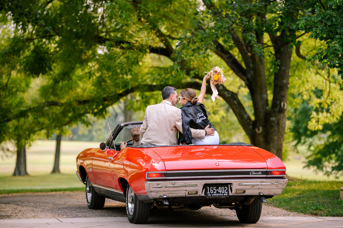 Bride and Groom riding away in convertible
