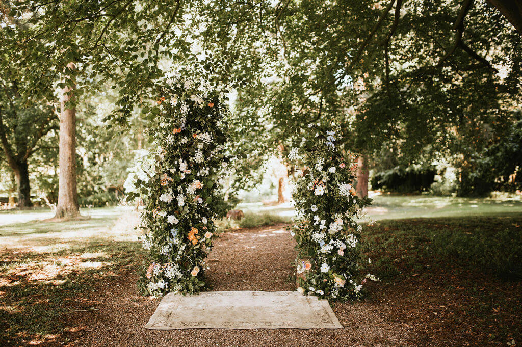 Broken arch of flowers for an outdoor ceremony at Broadfield Court