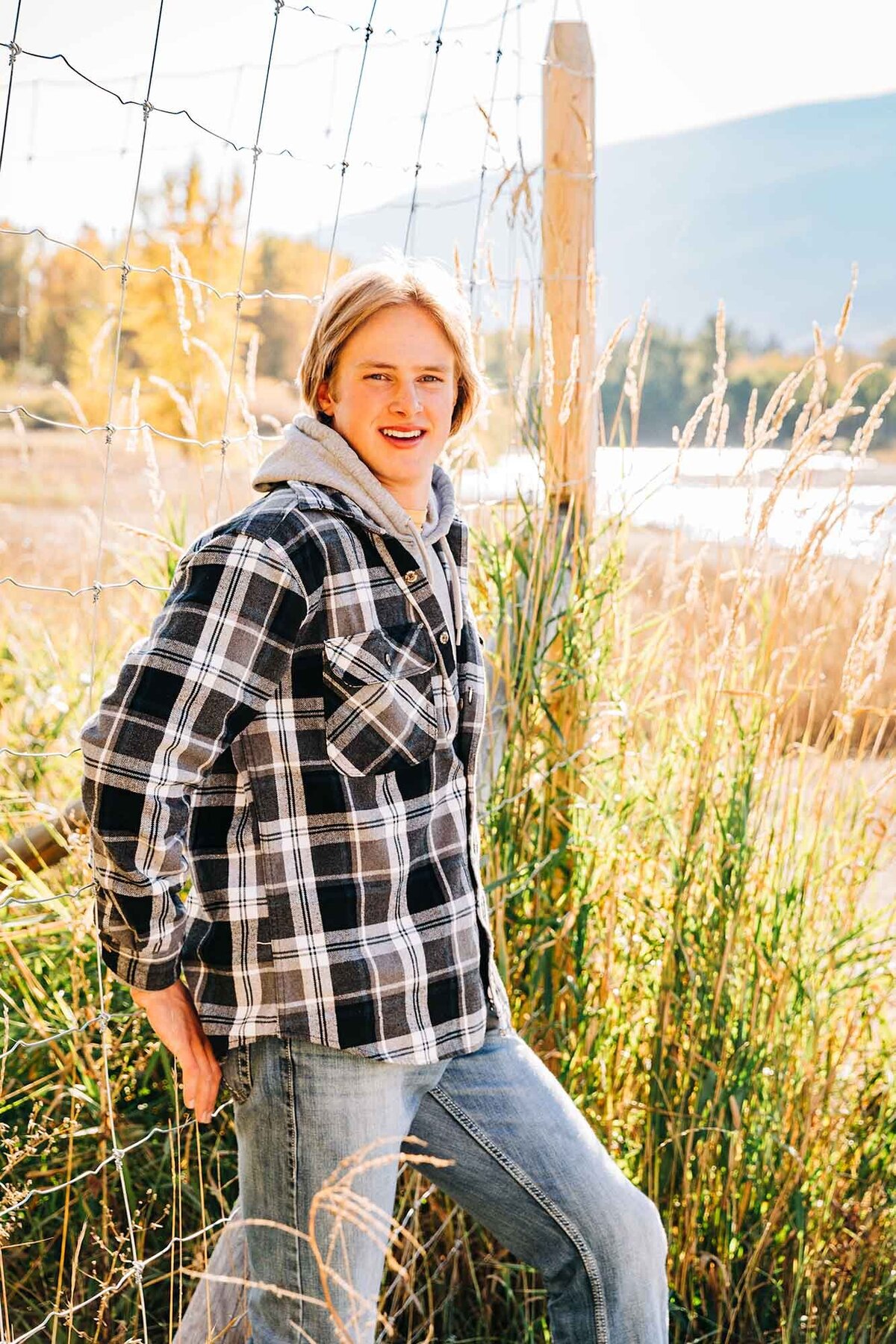 Male senior photo outside by river, Hamilton, MT