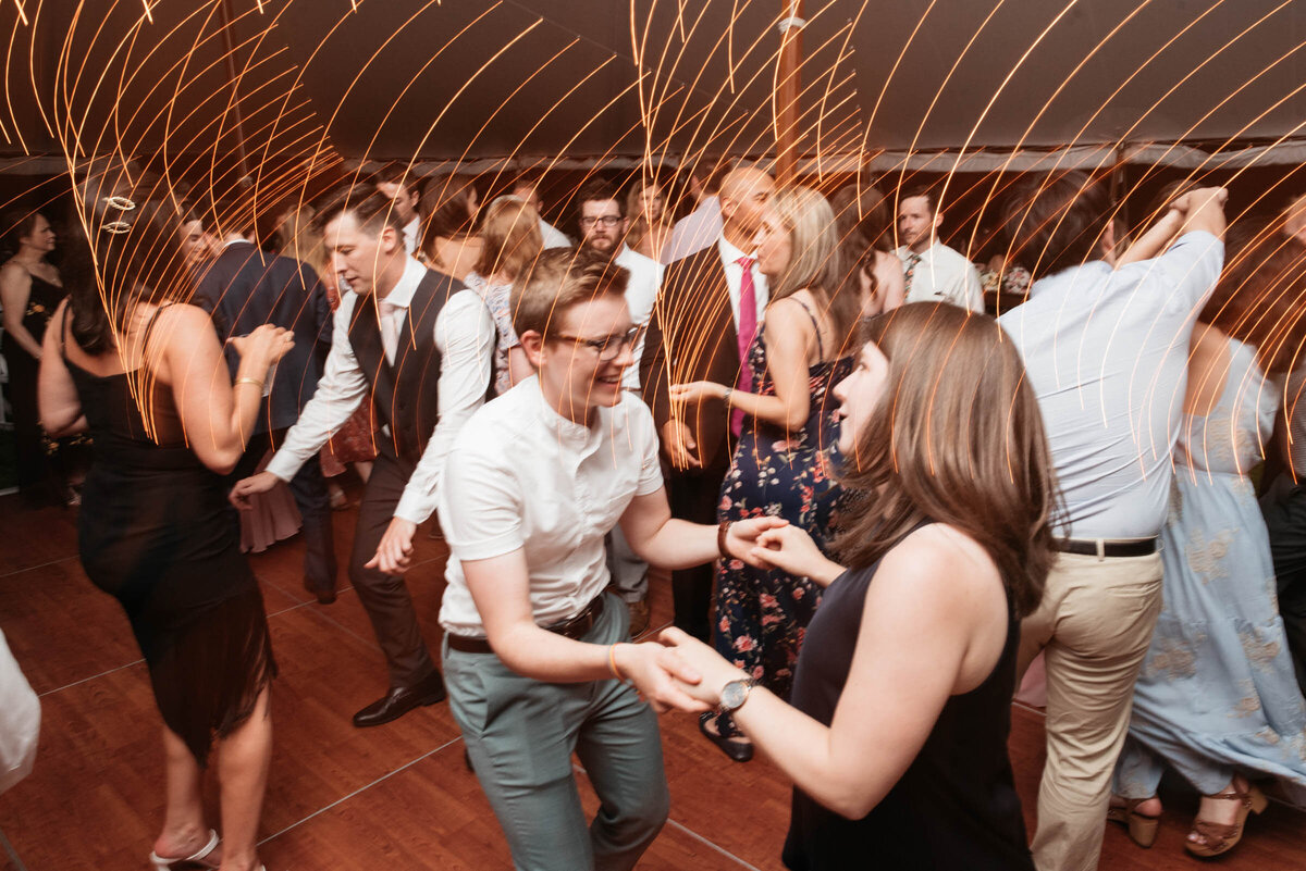 guests dancing at tented wedding reception in boston