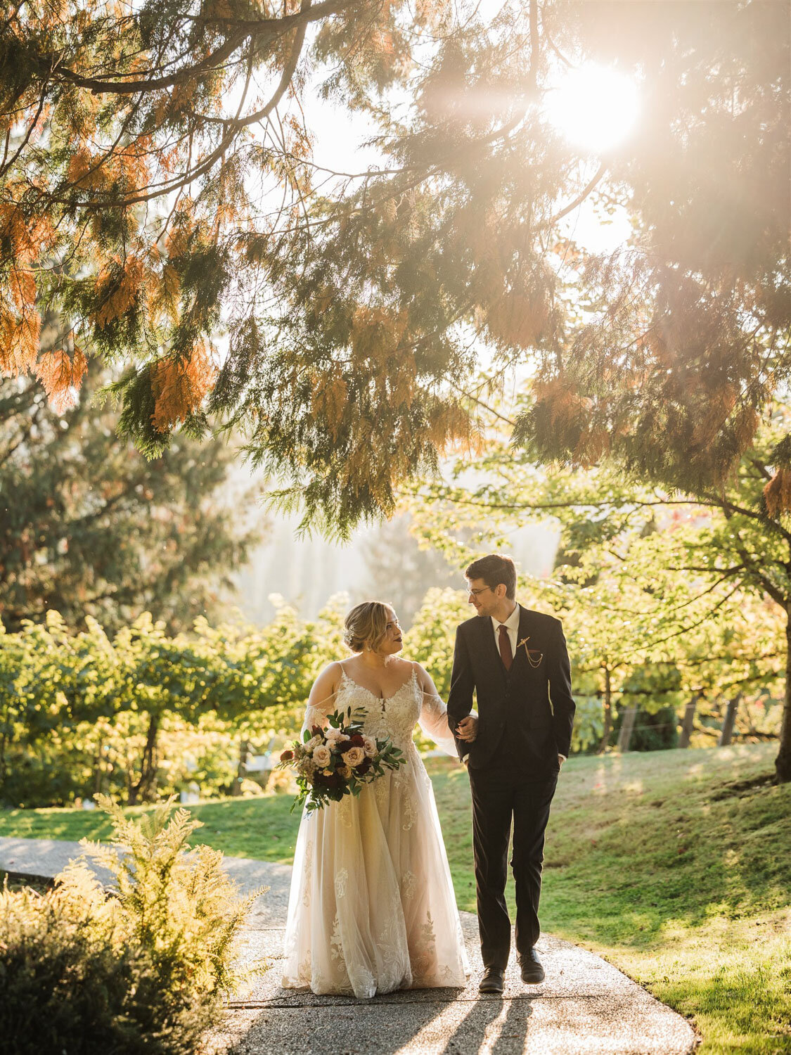bride and groom  sweetly walking  while holding each other's arms