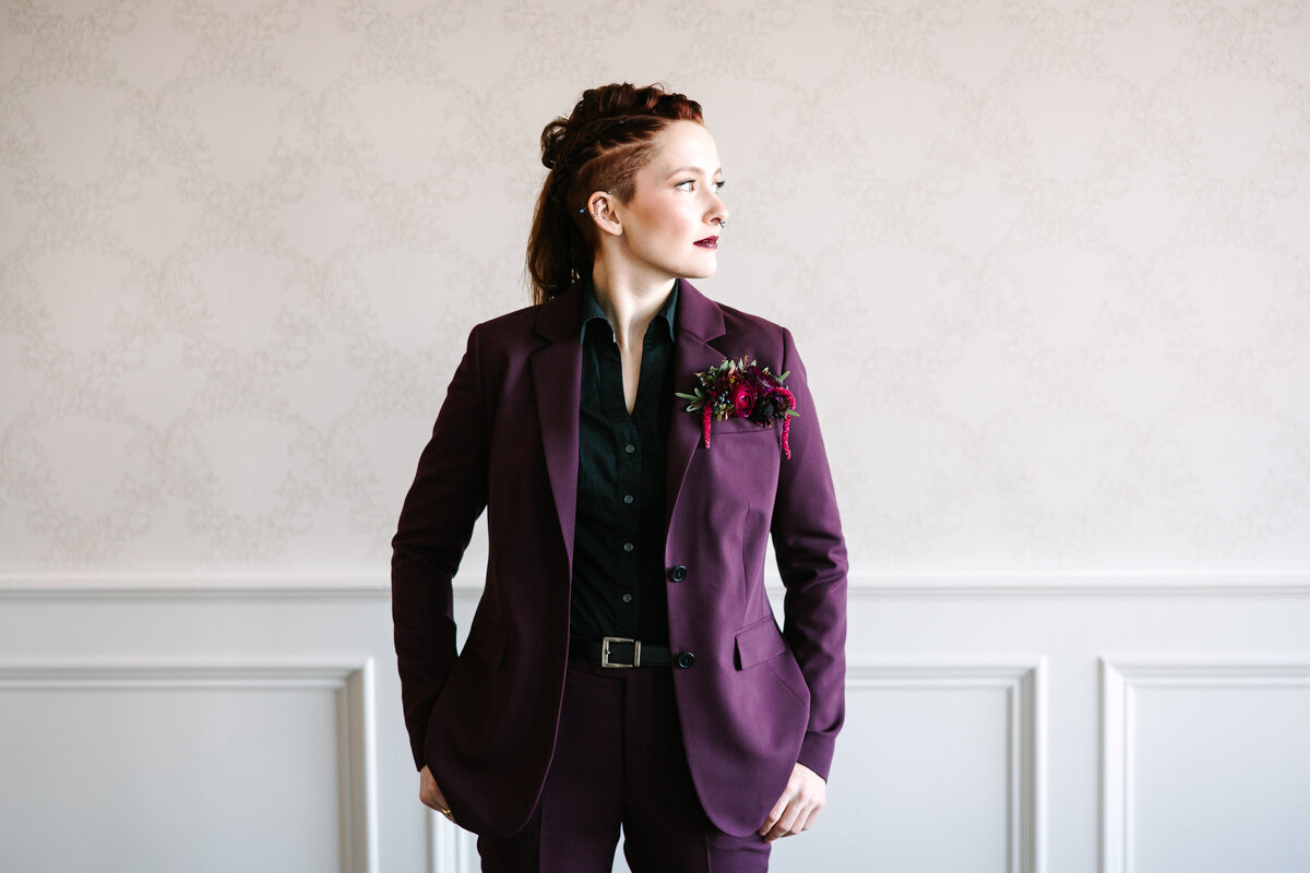 Bride in purple suit looking to the right