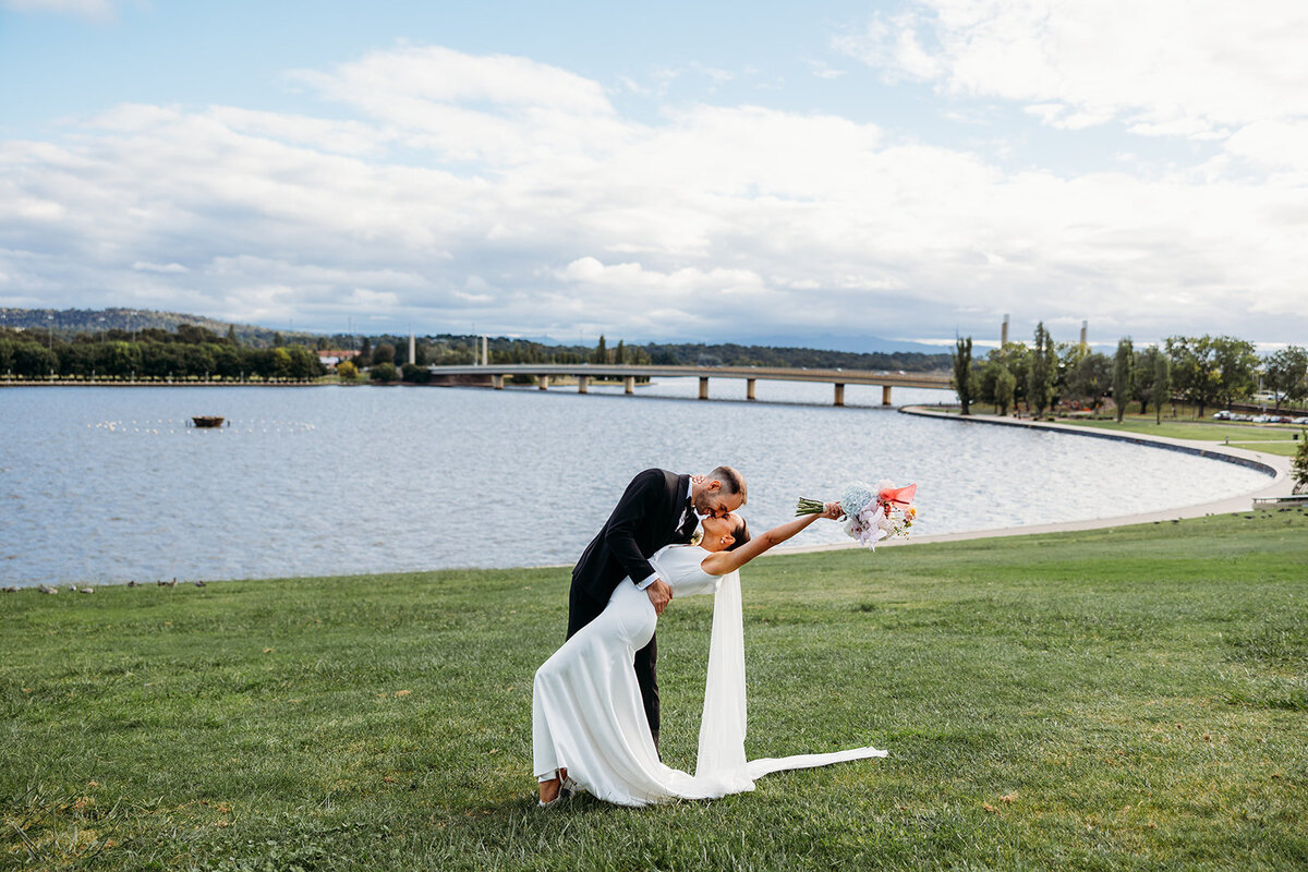 Bride and groom portraits overlooking Lake Burley Griffin in Canberra ACT