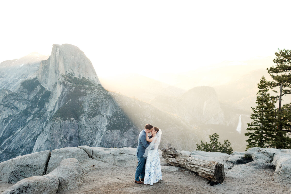 A couple enjoys their wedding day in front of the iconic half dome, from the view of Glacier Point in Yosemite National Park.
