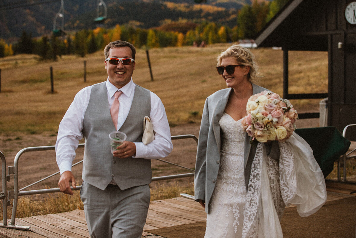 married couple walks through asoen mountains