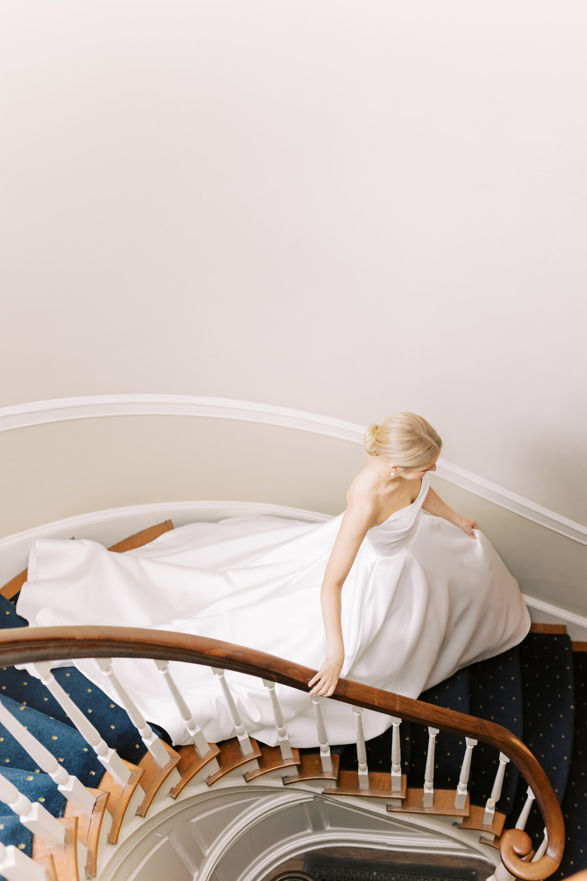 Bride walking down stairs at Appleford Estate in Villanova, Pennsylvania