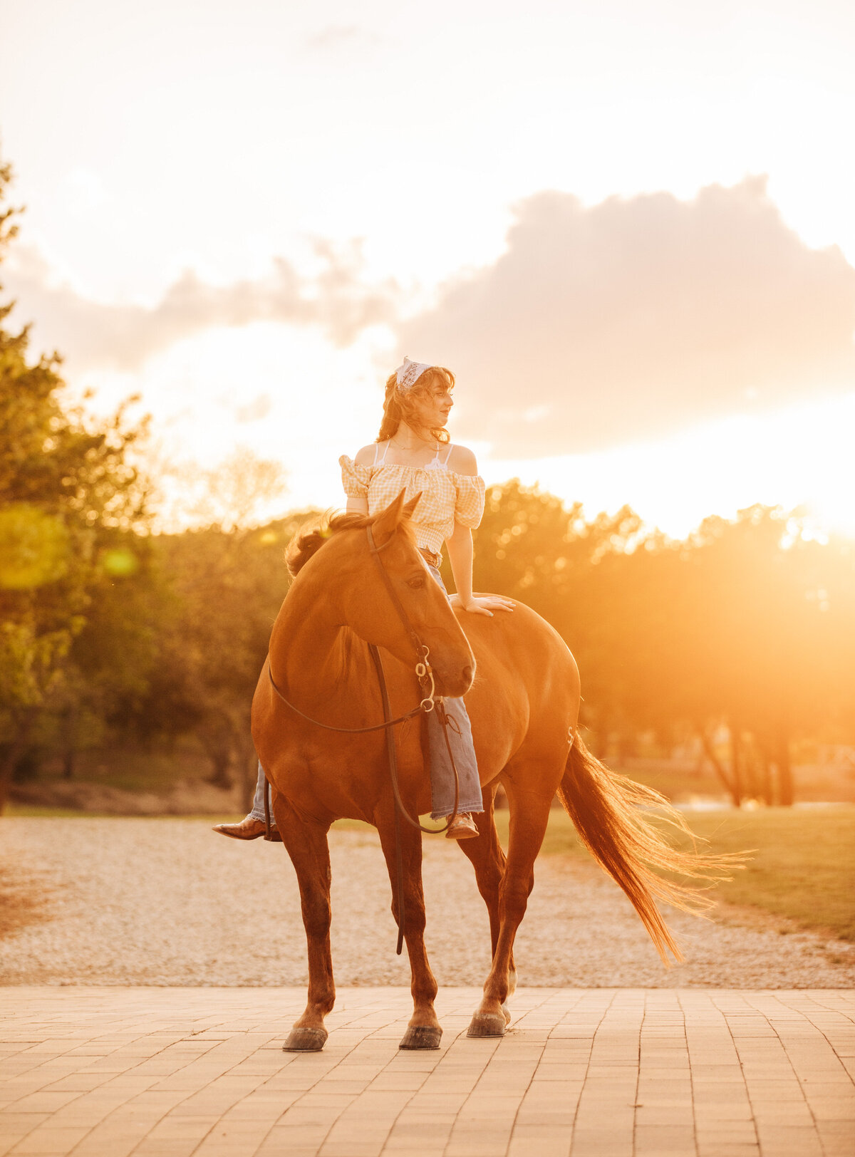 girl sat bareback on her horse at sunset