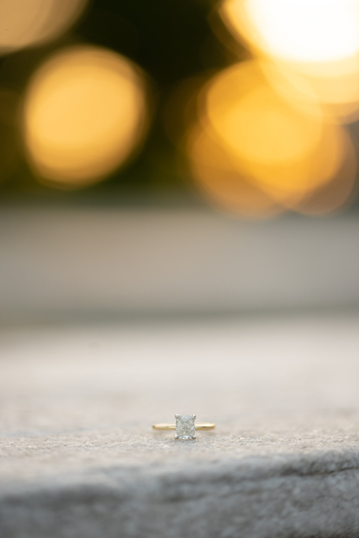 Bride's wedding ring sits on stone and marble ledge at golden hour/sunset of a wedding/engagement session at the Cleveland Museum of History in Cleveland Ohio. Photo taken by Aaron Aldhizer