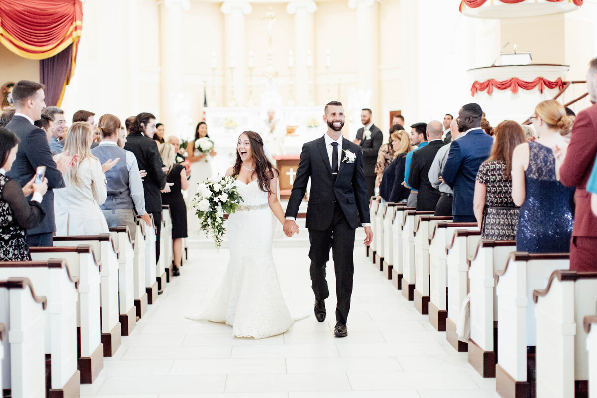 Bride and groom walking down the aisle after getting married.
