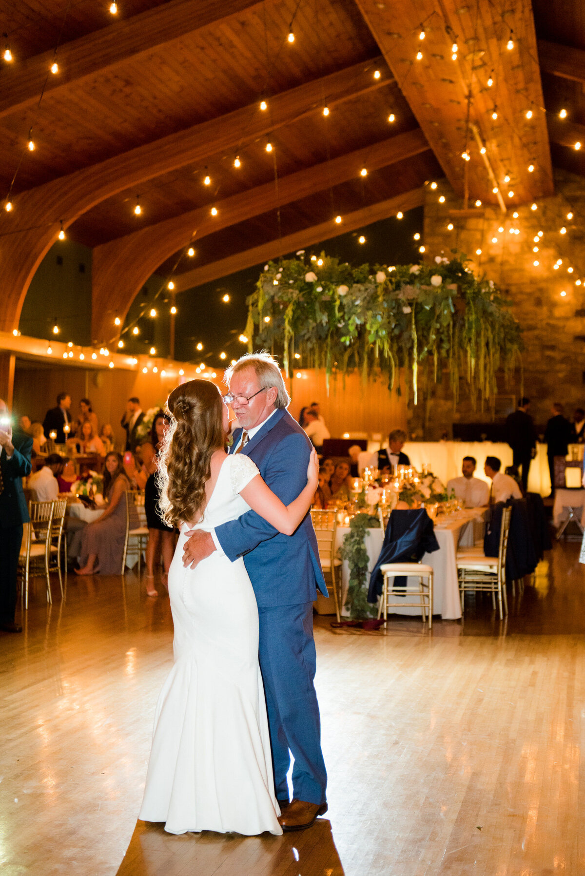 father daughter dance in glessner auditorium surrounded by twinkle lights and greenery
