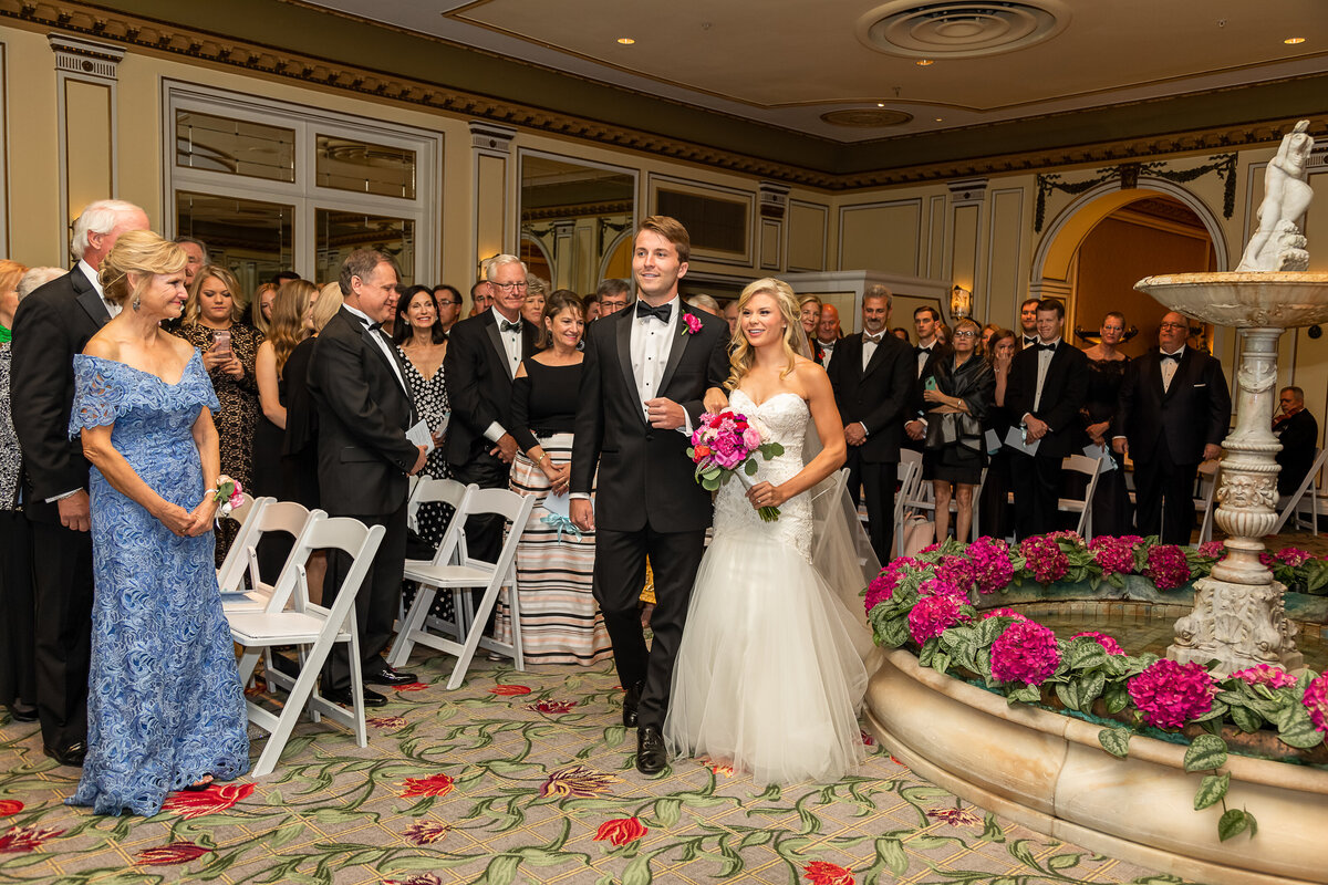 Bride and her escort walk down the aisle at the Broadmoor