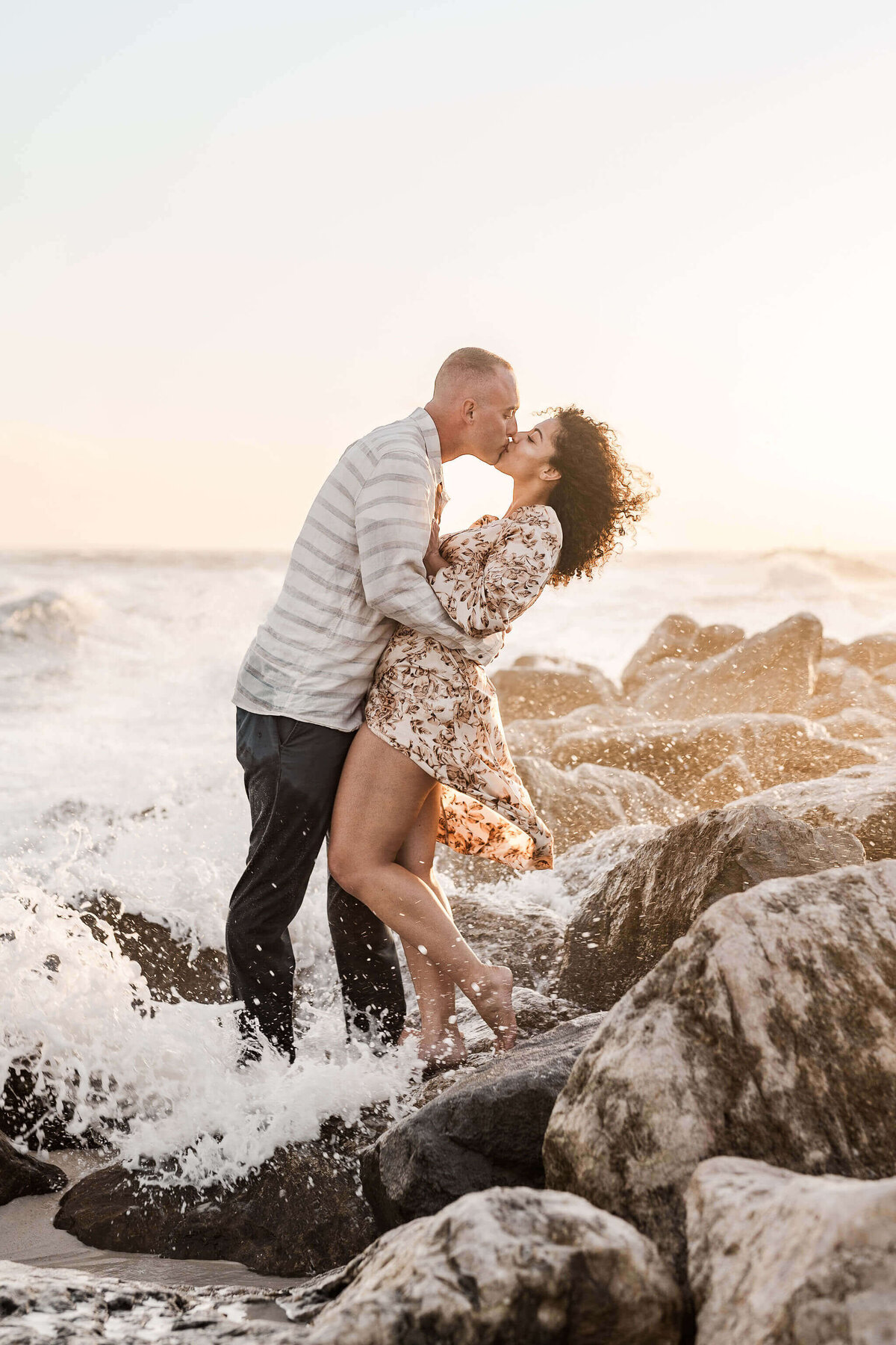 Beach-Engagement-Photos-Wedding-Photographer-Videographer-Mobile-AL-Birmingham-Engagement-Orange-Beach-Alabama-Point-The-Pass-Nick-Sarylee-Sunset-Rocks-Wave-Crashing-During-Kiss