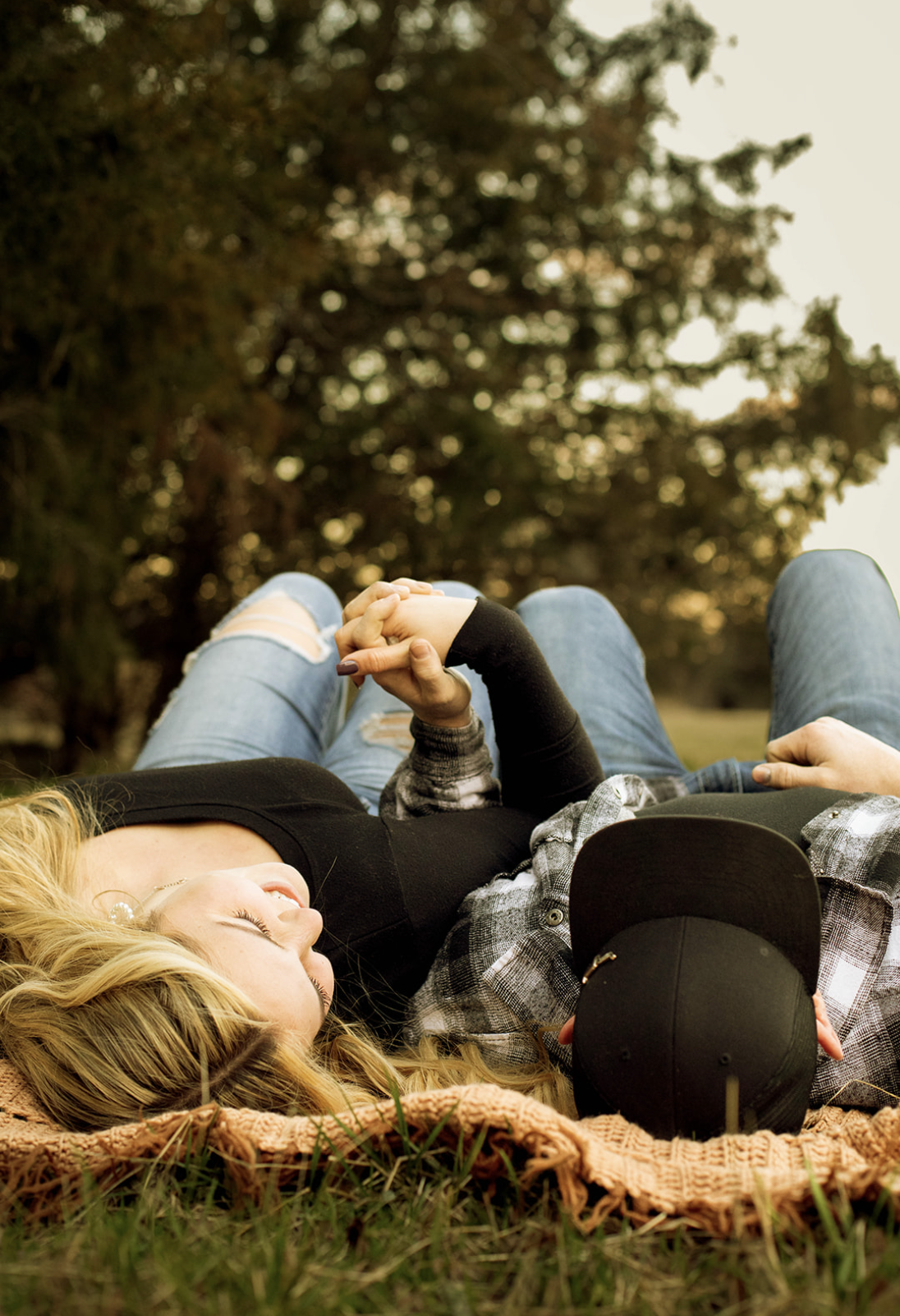 cozy-couple-laying-on-blanket.
