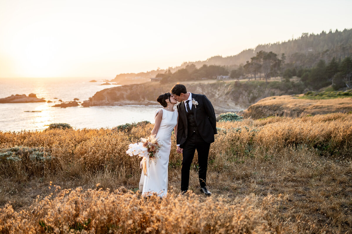 San Francisco Bay Area wedding photographer captures editorial couple portrait at Timber Cove Resort with dramatic Sonoma Coast cliffs and golden hour lighting