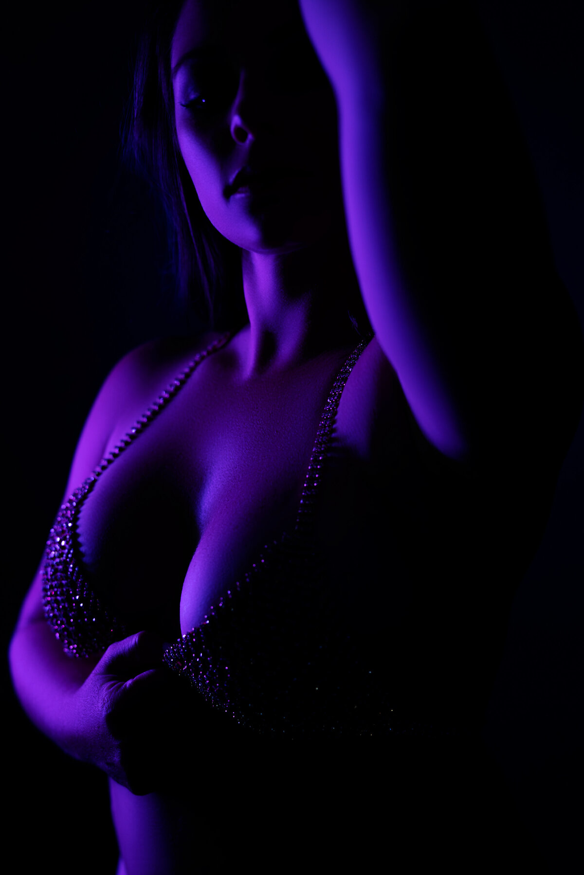 black and purple silhouette of womans face and chest