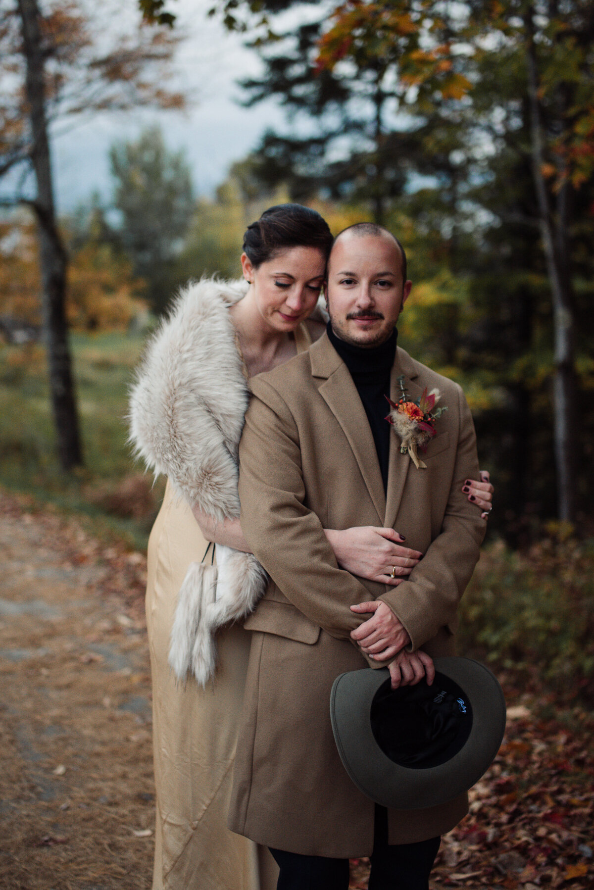 Couple embraces wearing vintage inspired outfits with florals by Blossoming Bough