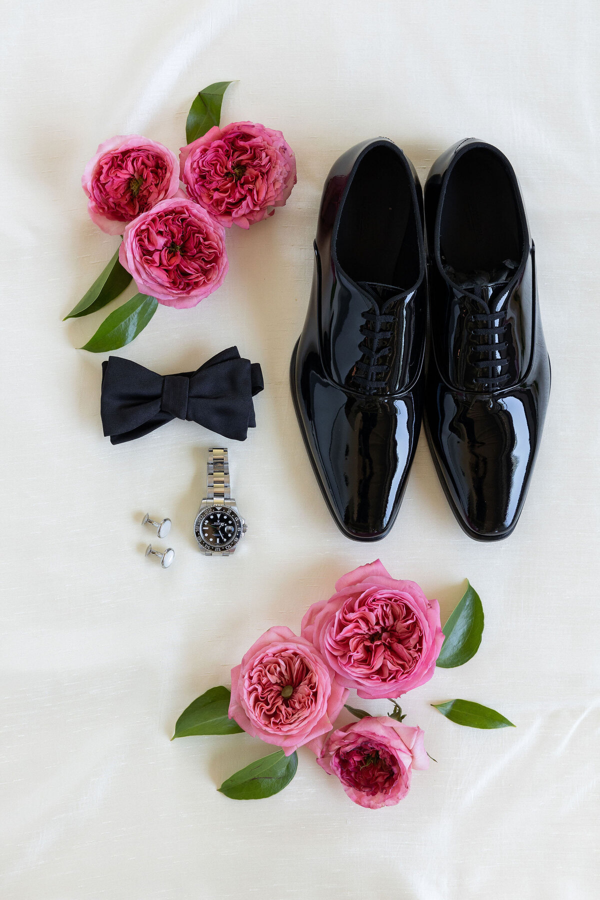 Flat-lay with groom shoes and rolex