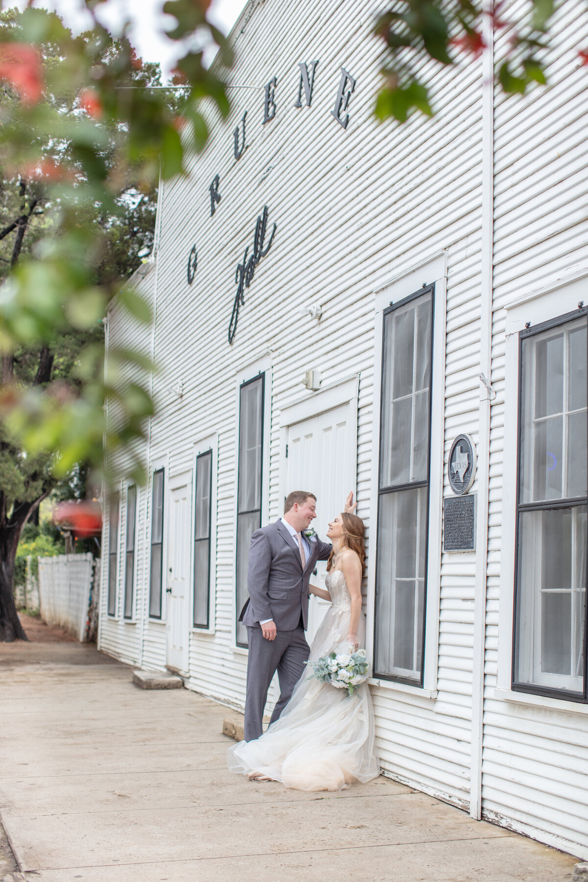 bride and groom at Gruene Hall in wedding attire by Firefly Photography