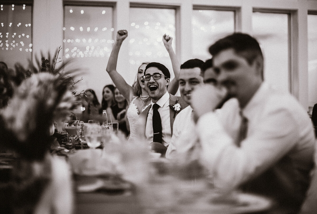candid moment of cheering during wedding reception