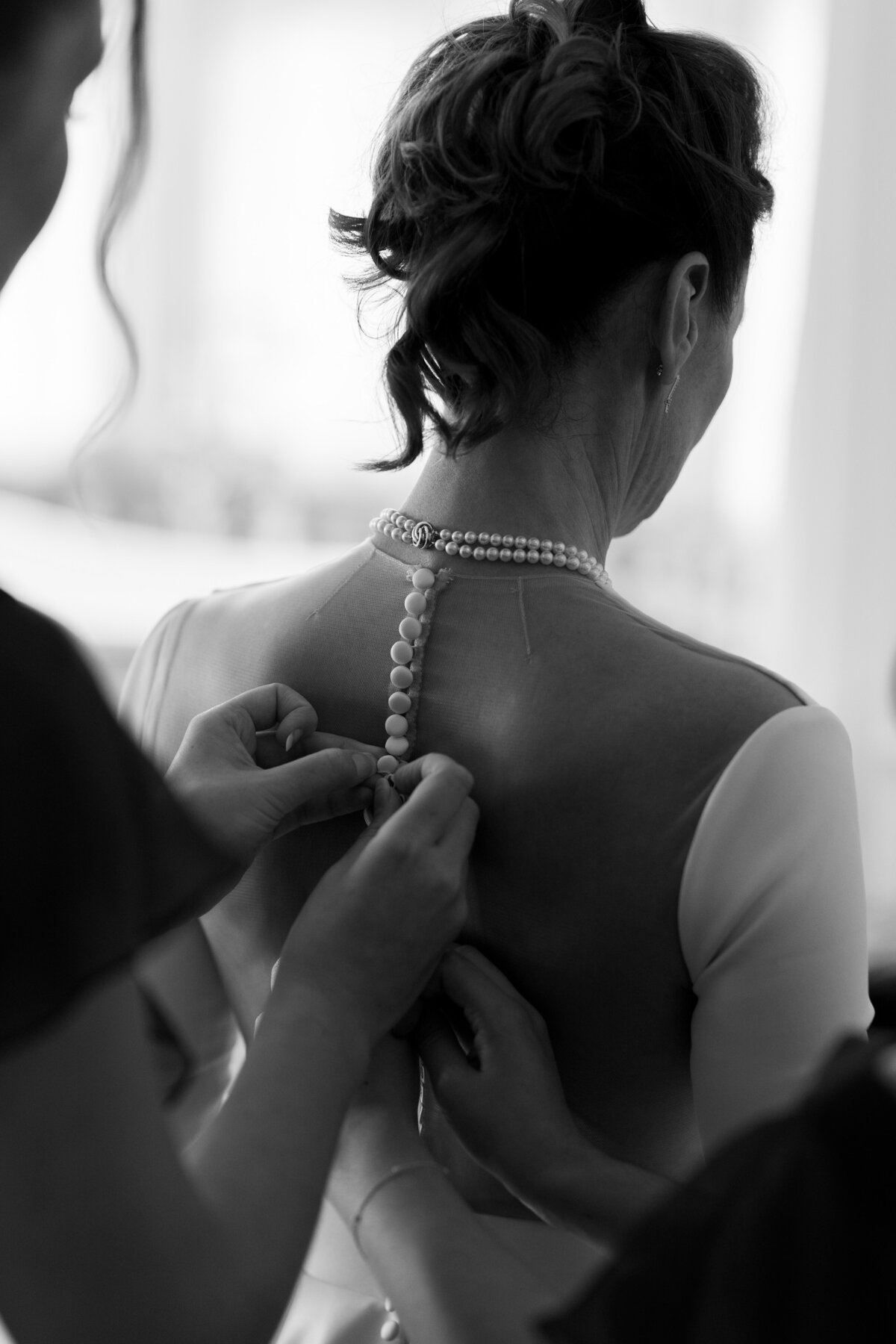 The bride gets into her Justin Alexander wedding dress