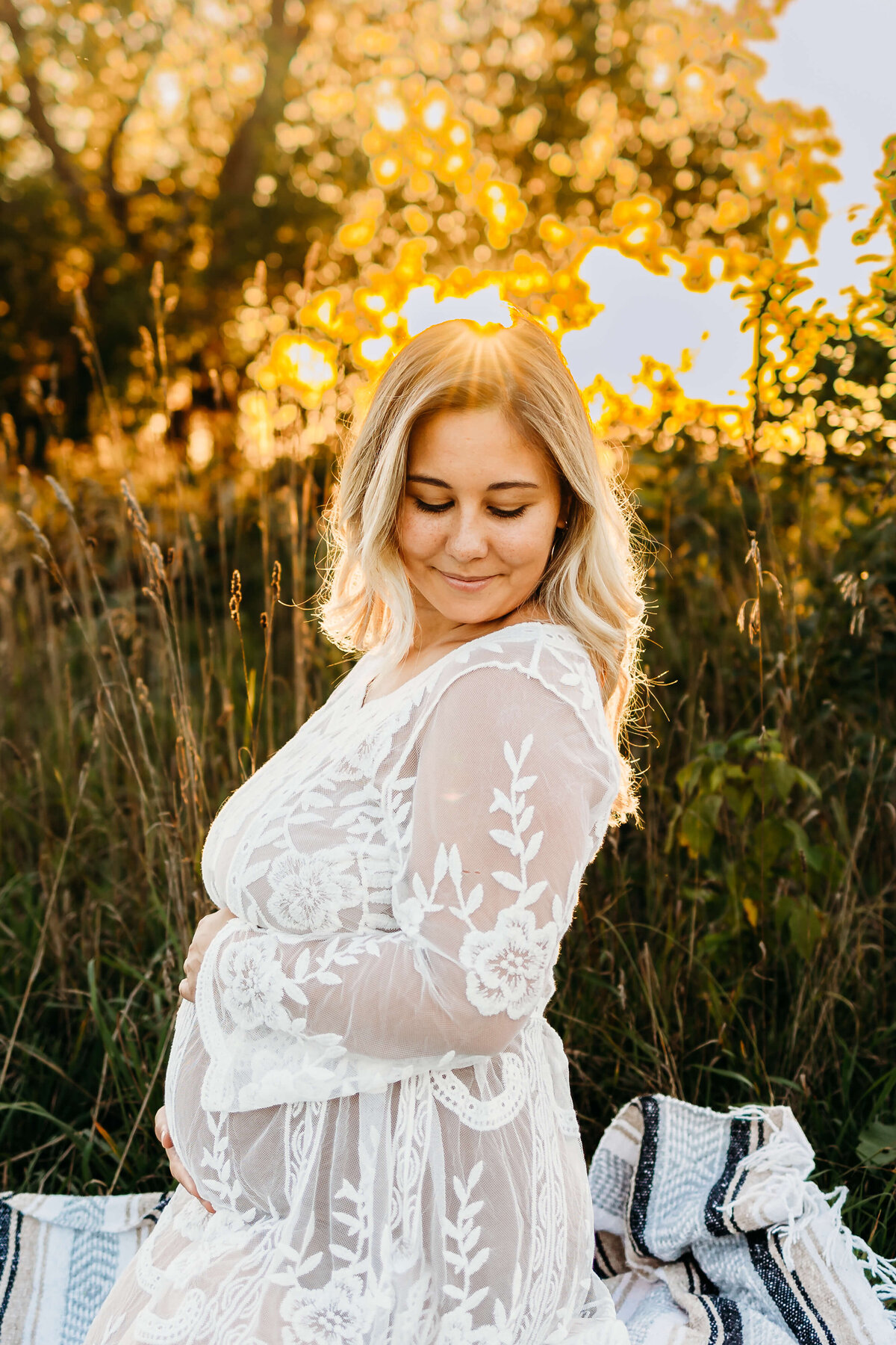 Mom to be in white dress golden hour field session