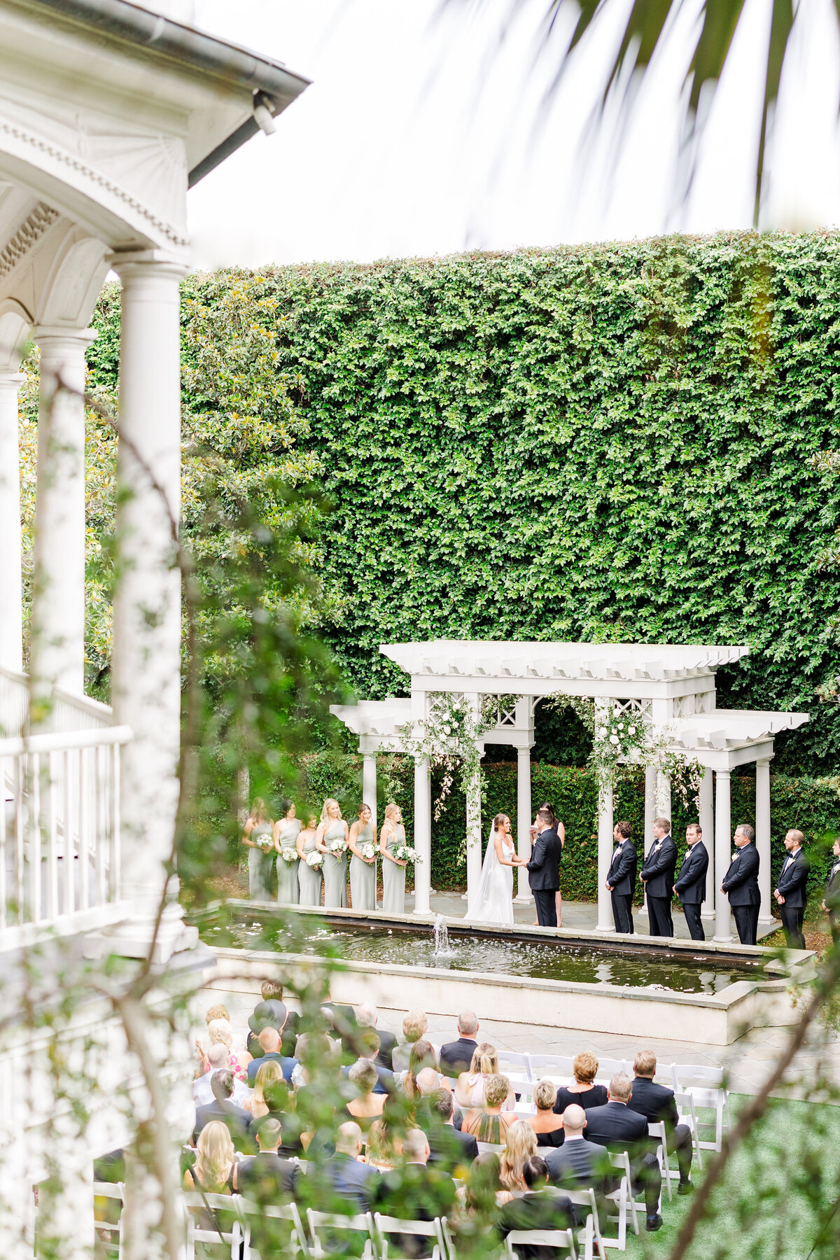 wedding ceremony by the  pergola at the william aiken house
