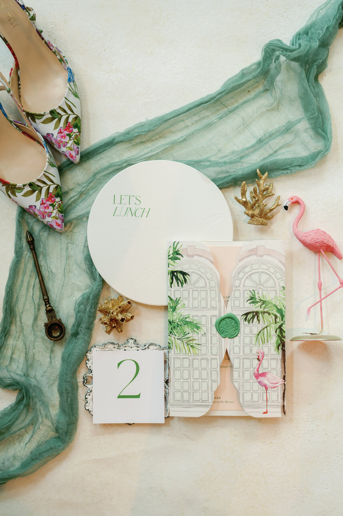 A stylish flat lay featuring an elegant menu card paired with designer shoes and sophisticated accessories. The refined composition highlights luxury and attention to detail, making it a perfect inspiration for upscale event styling and fashion-forward celebrations.
