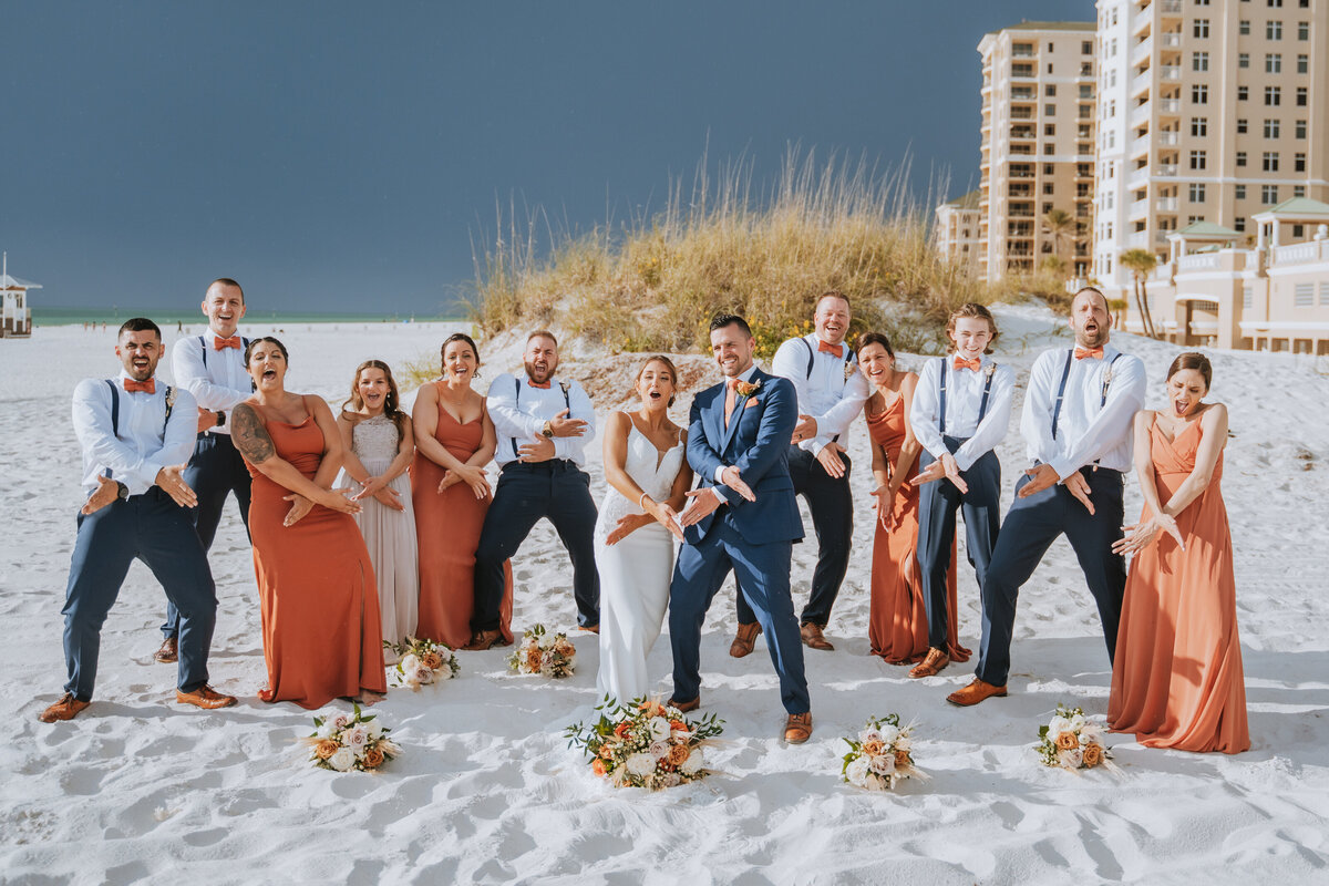 entire wedding party on beach having fun hilton clearwater