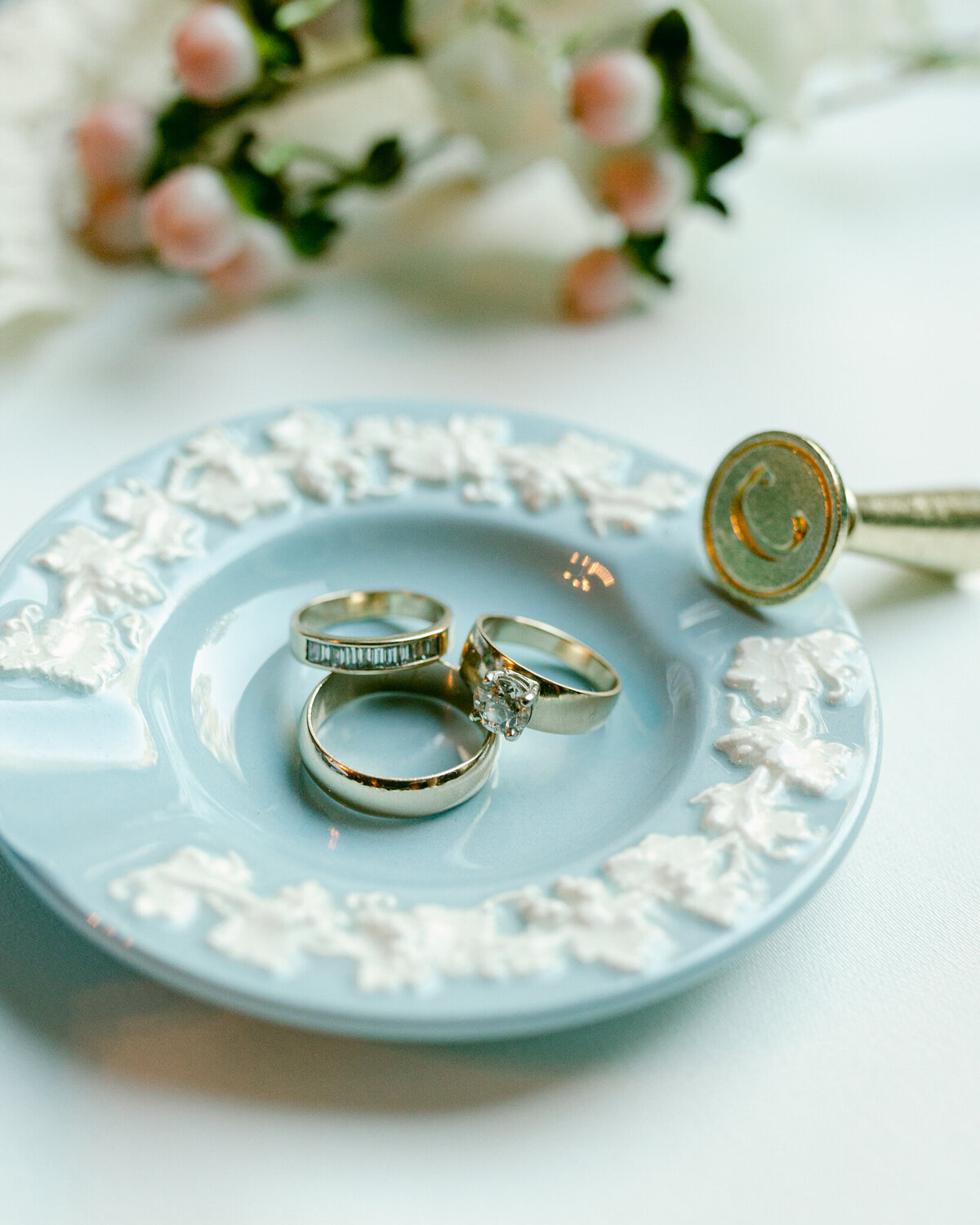 close up photo of brides rings in blue tray