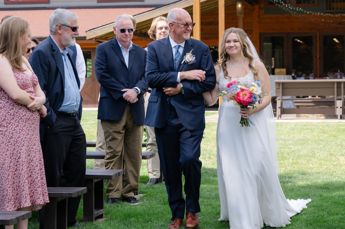 bride and father walking up wedding ceremony aisle at trinity tree farm issaquah washington