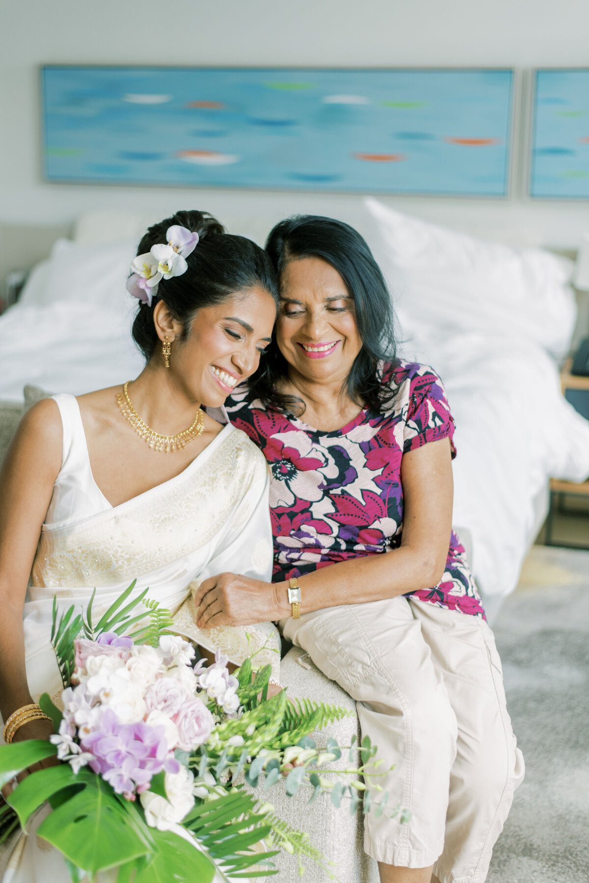 Indian mom and daughter haring a moment together before mom gets ready for indian wedding