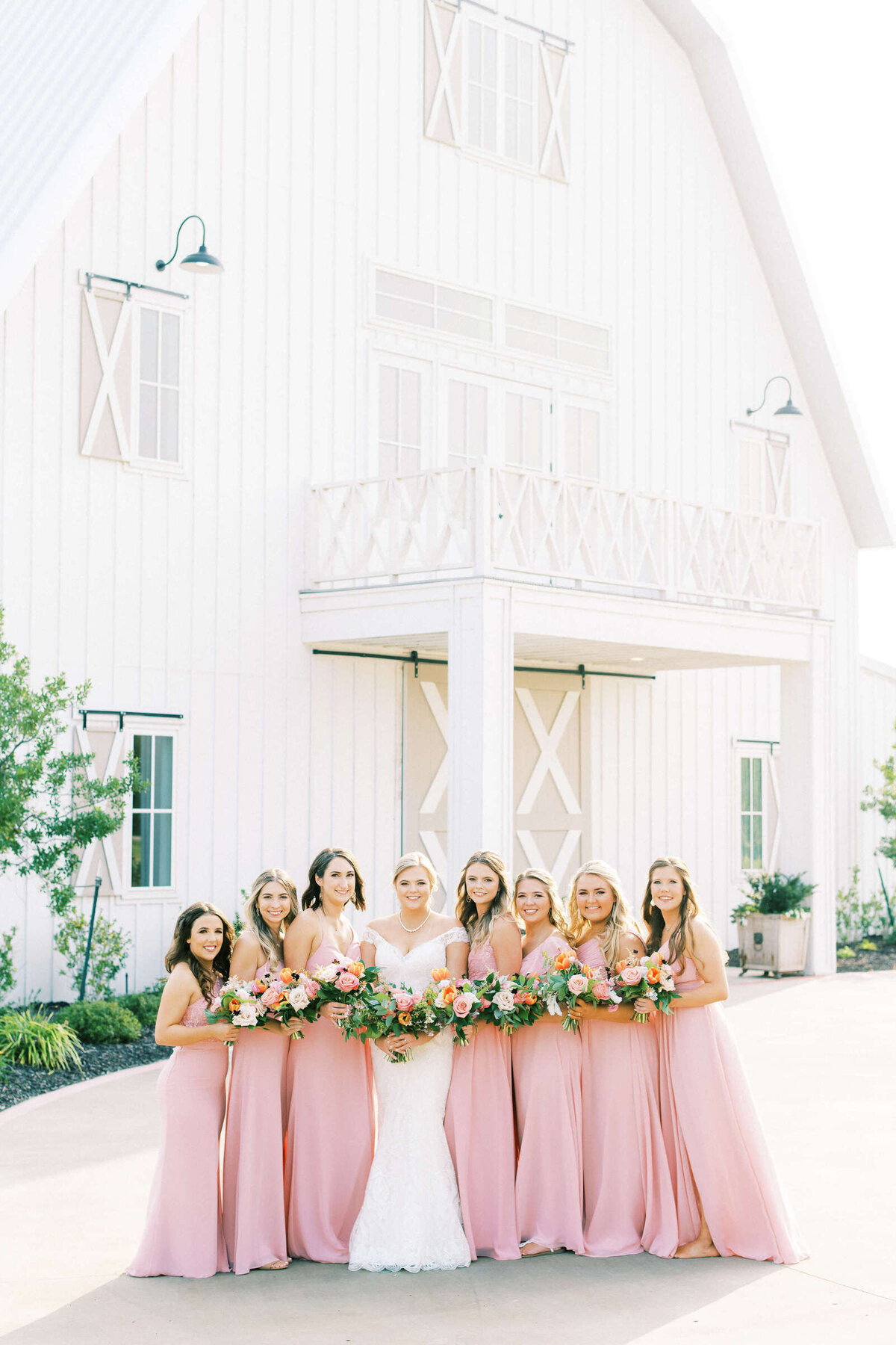 Bridal party stands outside North Texas wedding venue at summer wedding