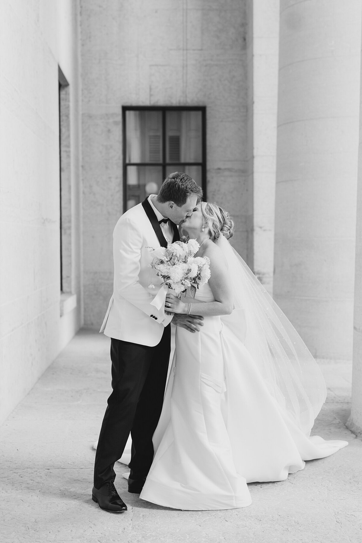 black and white wedding photo by Columbus wedding  photographer with bride and groom kissing