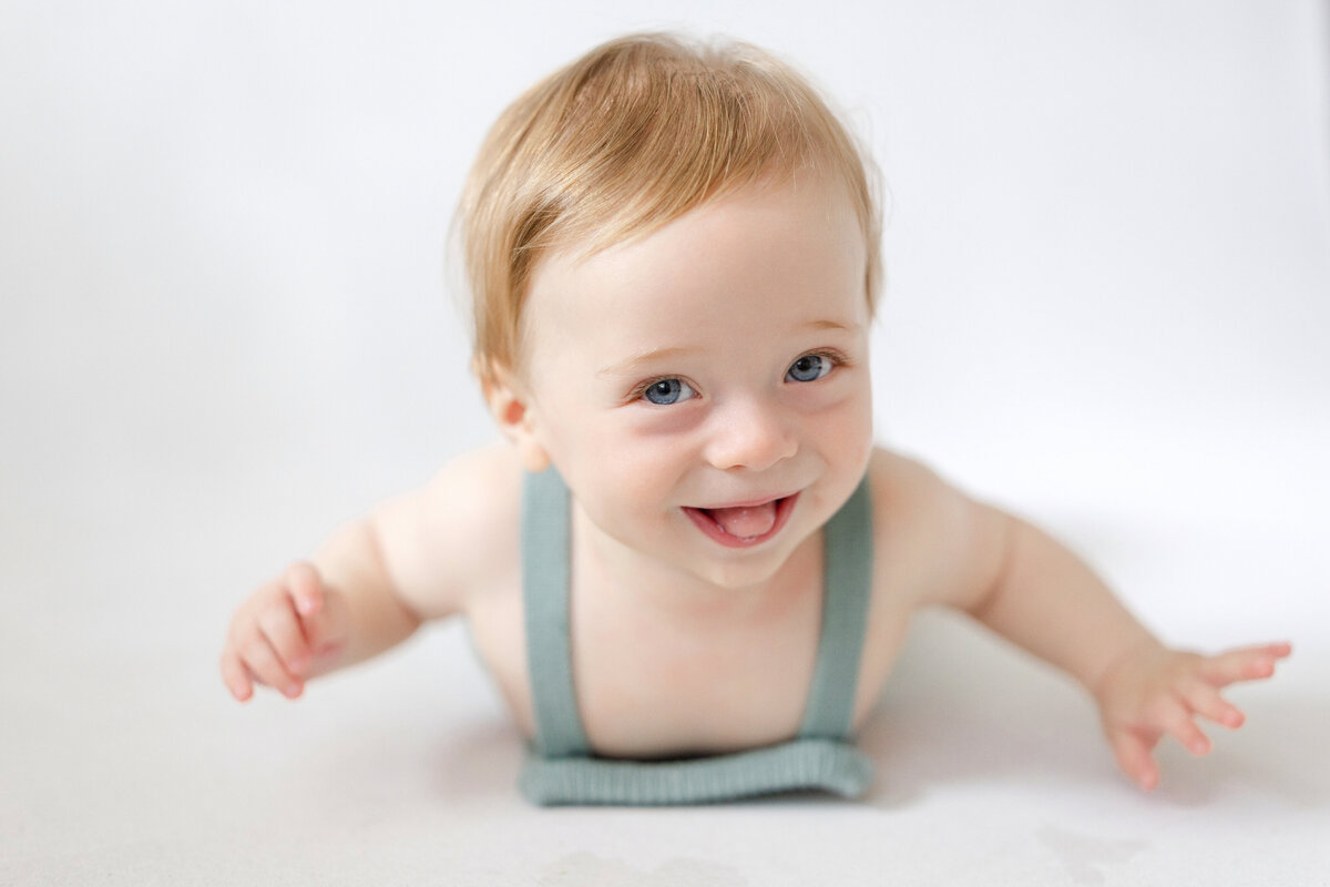 Tampa 6-month milestone portrait of smiling baby boy in natural light studio