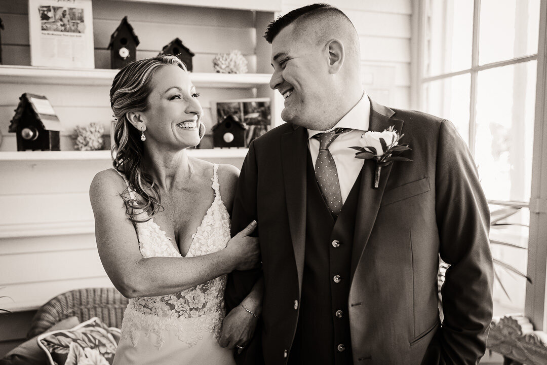 black-and-white-bride-and-groom-smiling-holding-arms-wedding-photo-nj