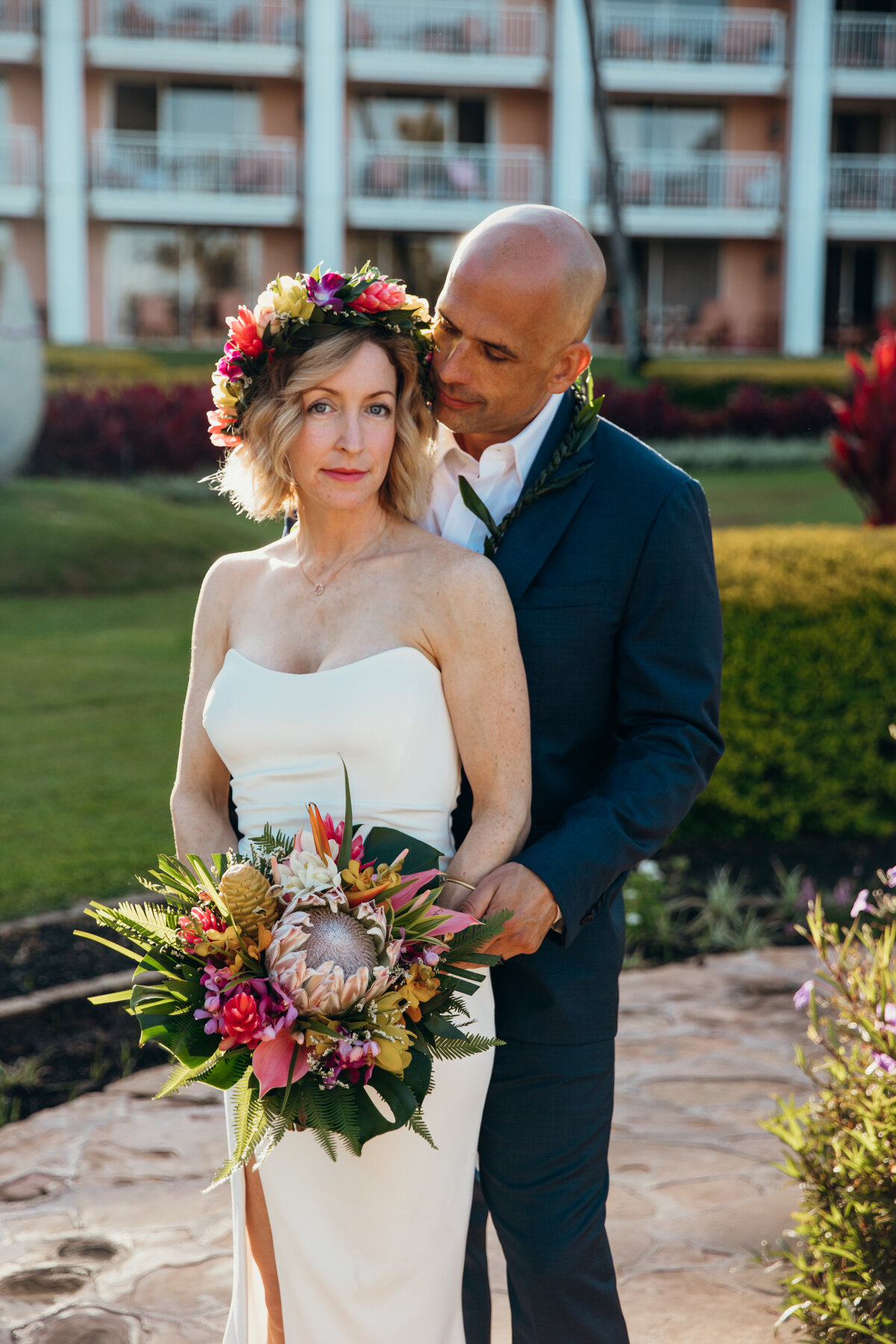 Maui Wedding Photographer captures bride wearing floral crown while groom holds her