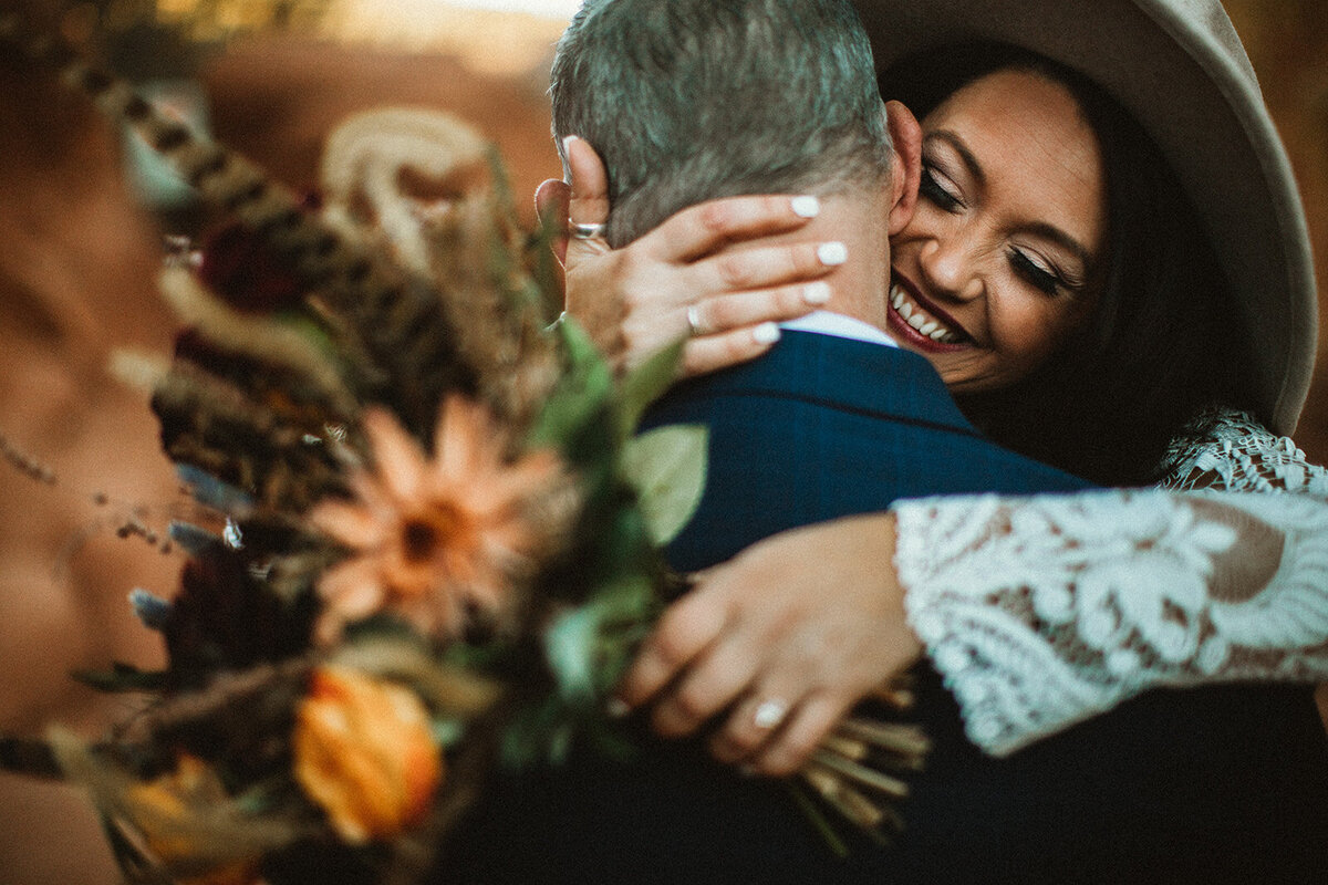 bride hugs groom in garden of the gods Co