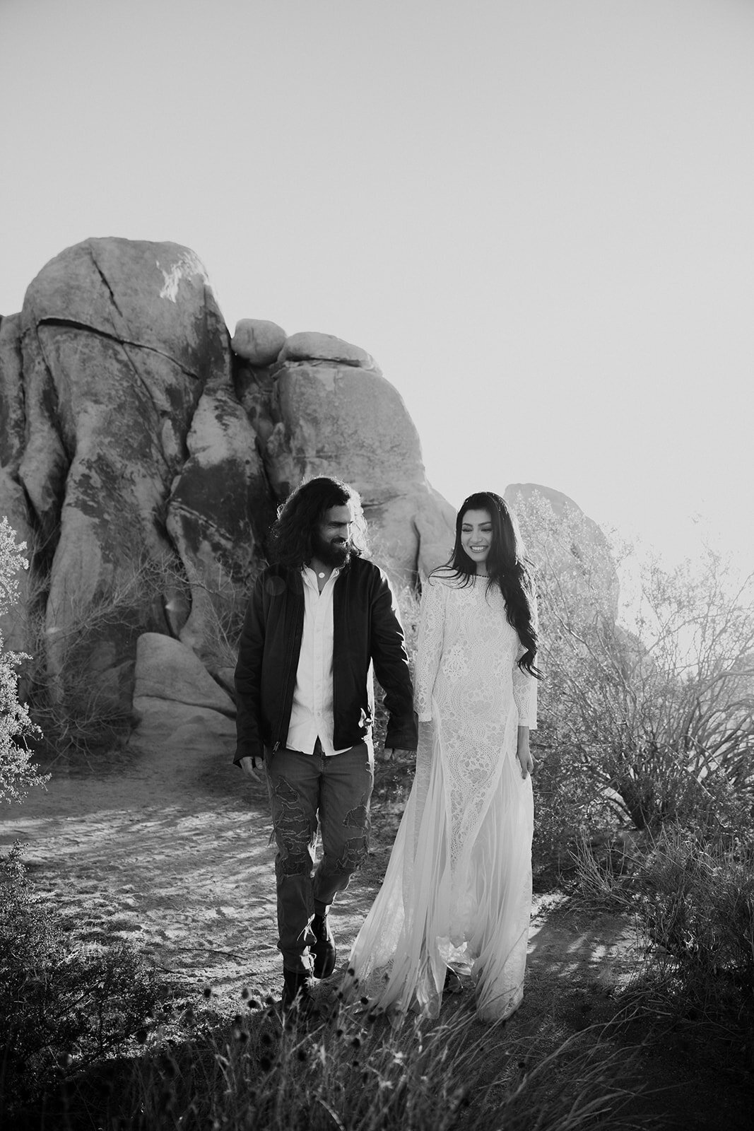 Wedding couple walking in front of rock formation