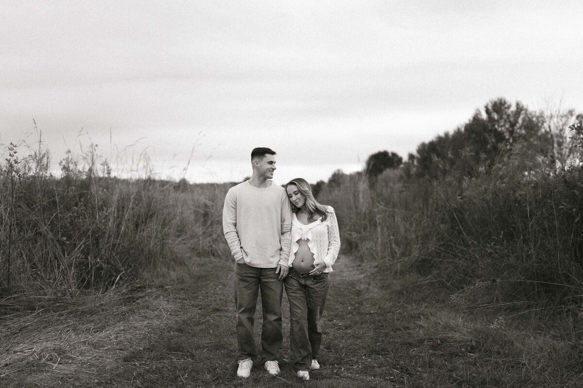 parents hold hands in a field in knoxville tennessee