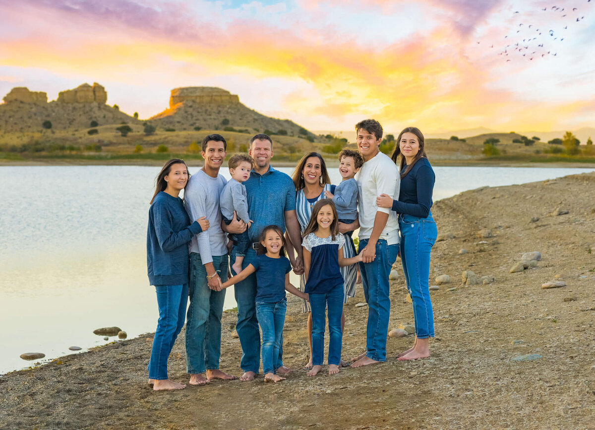 family of ten standing together on the beach near the Pueblo reservoir