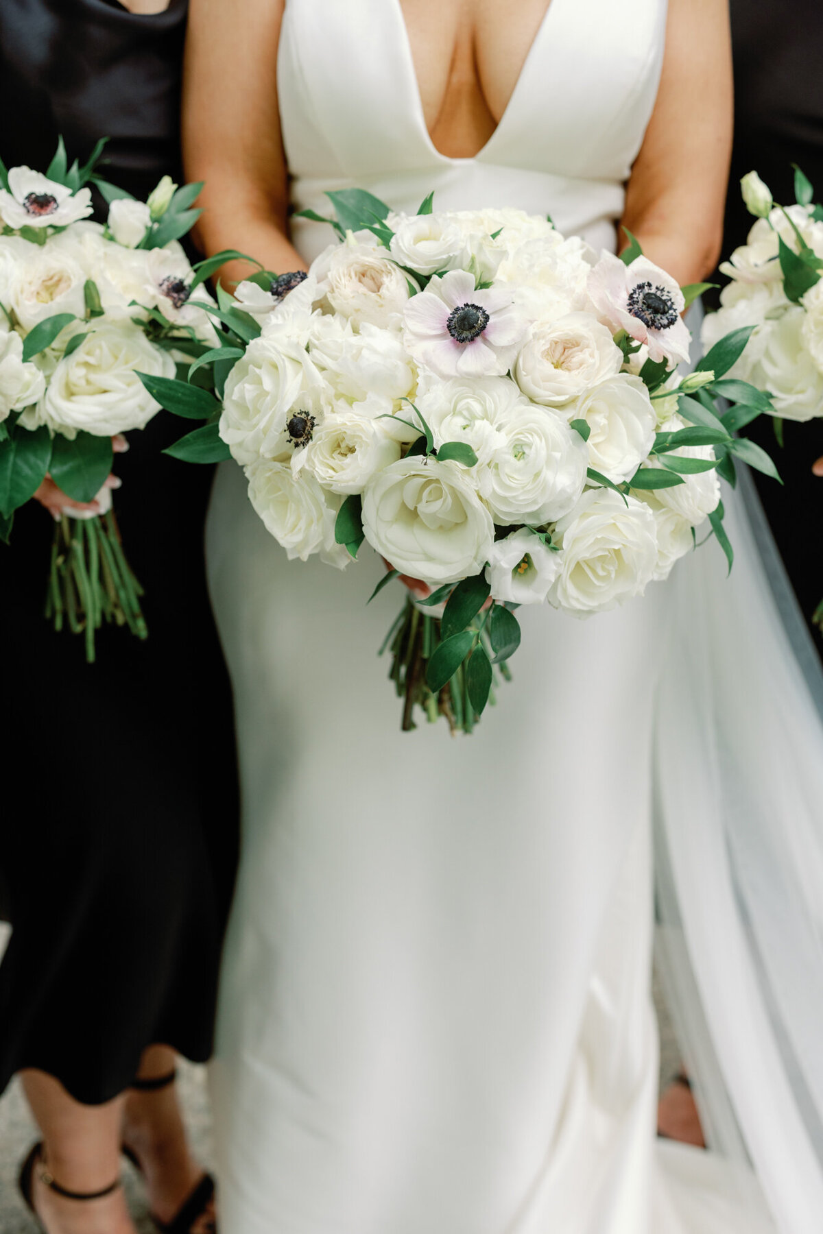 A beautiful wedding bouquet detail shot featuring the bride’s and bridesmaids’ white floral arrangements.