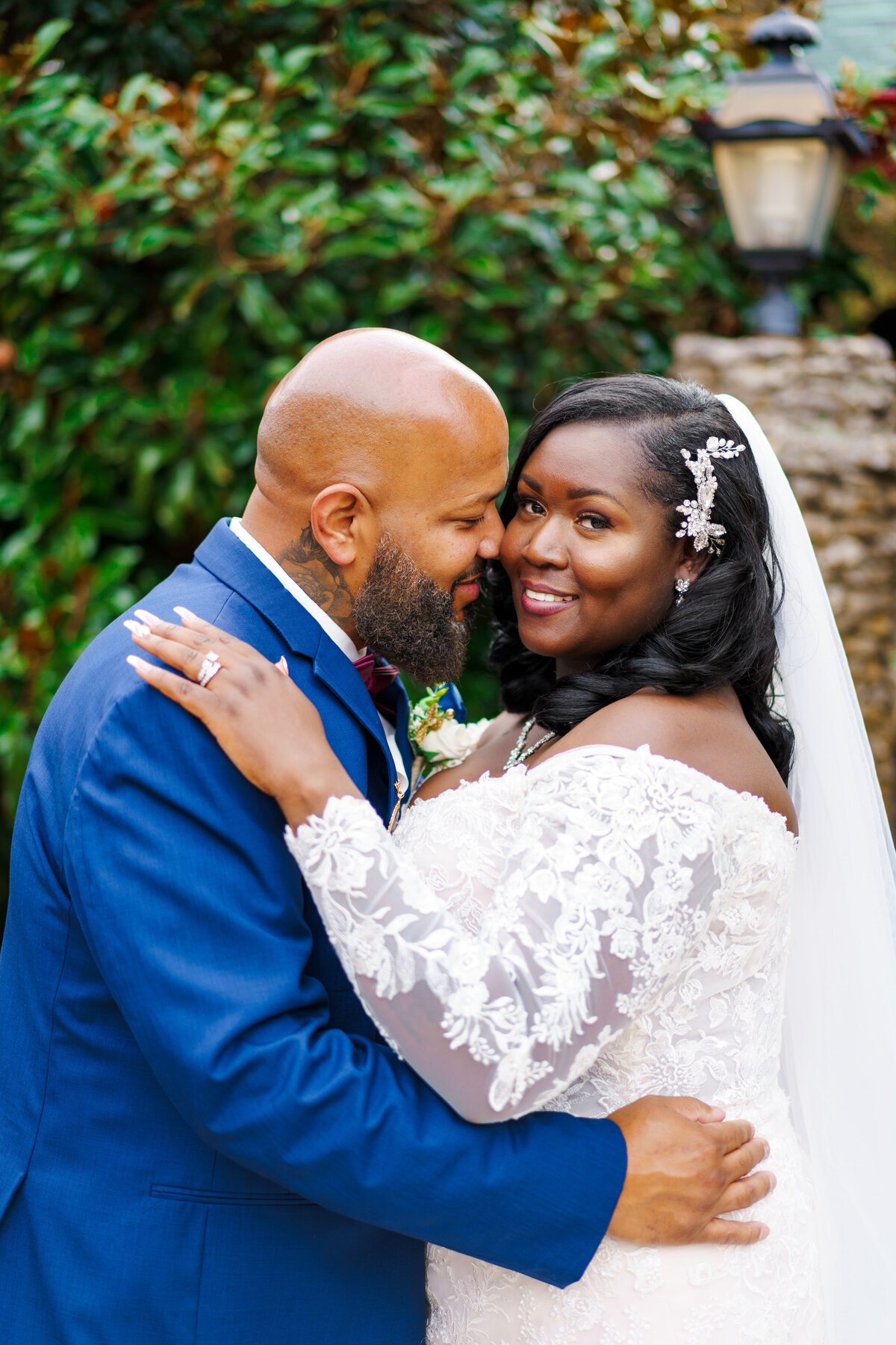 Groom snuggles his beautiful black bride as she smiles at their wedding at the Wigwam Event Center in Pickerington, Ohio.