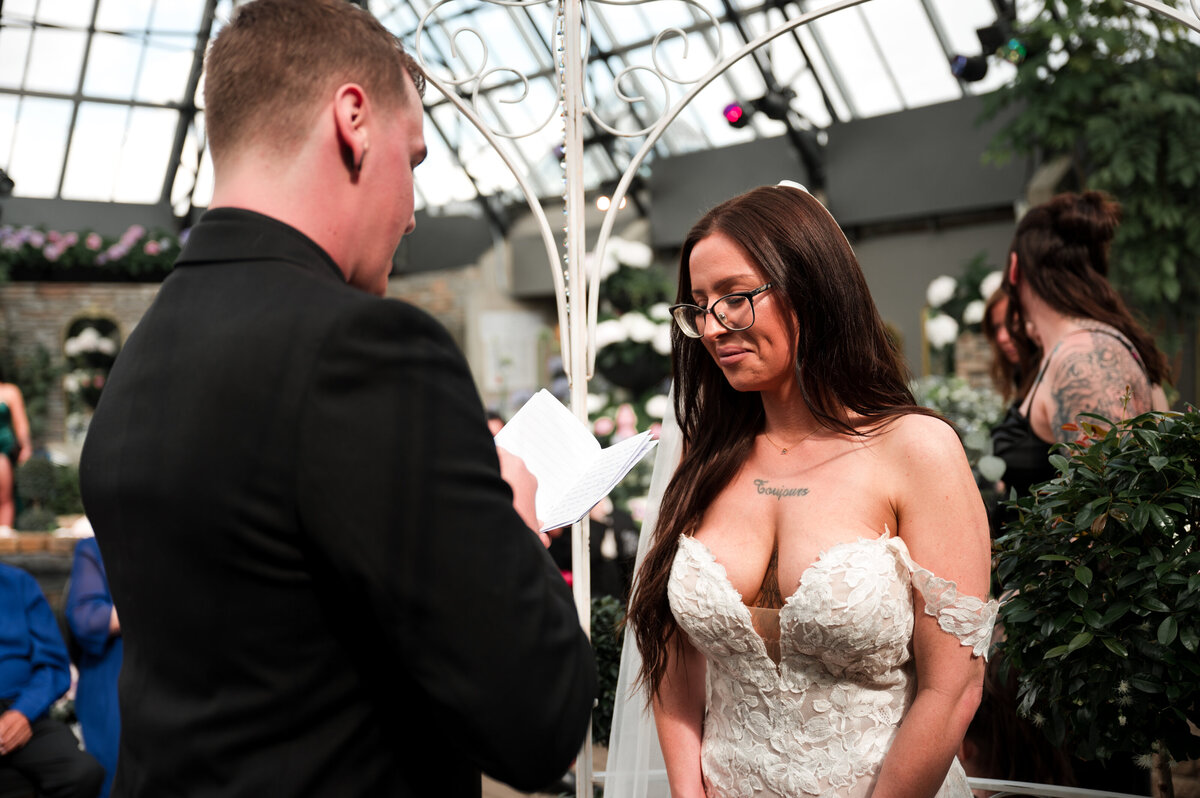 groom reading his romantic vows to the bride on her wedding day