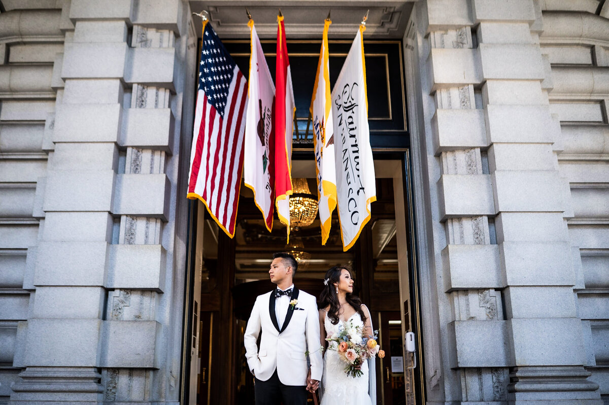Fairmont San Francisco wedding photographer documents couple's grand exit under signature flags and classical architecture