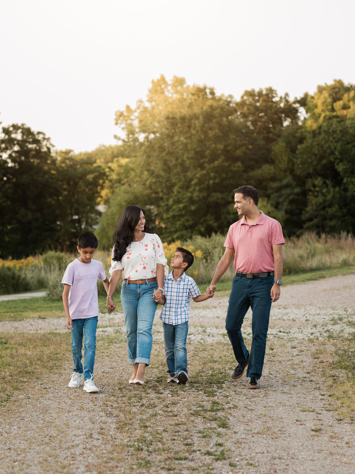 mom dad and two sons walking in park for family photos cleveland family photography
