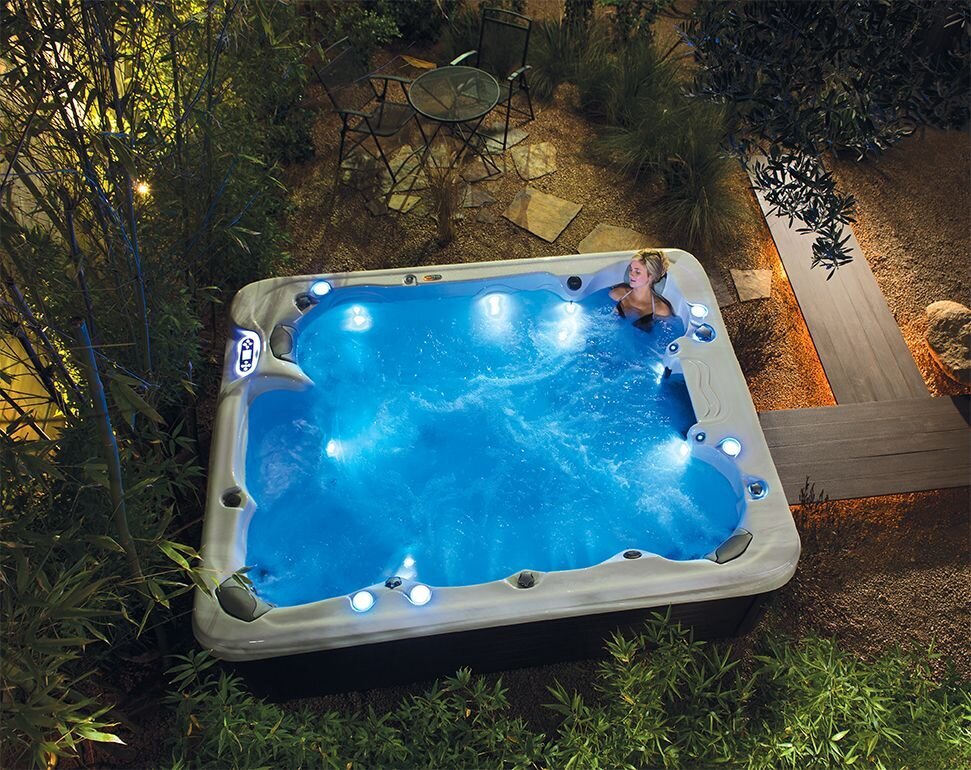 A woman sitting in a Maax hot tub.