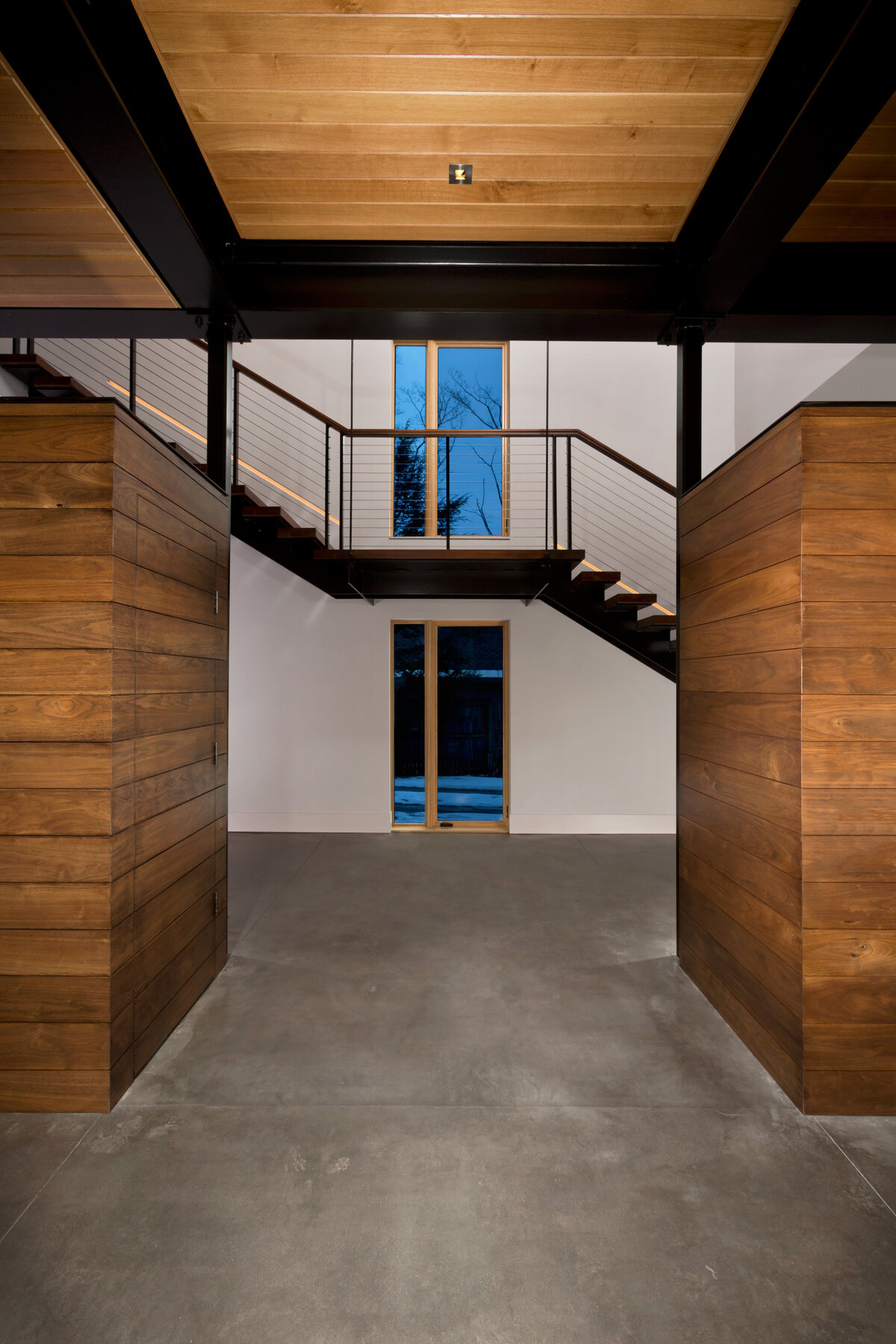 throughway with concrete floor and staircase in the background